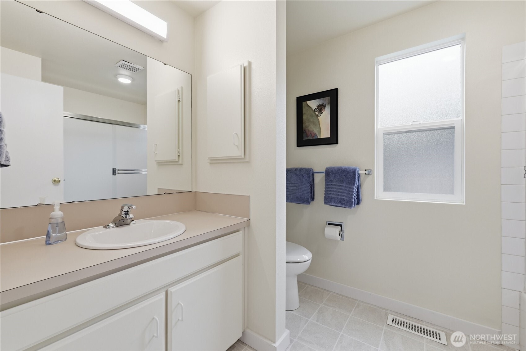 The main bathroom upstairs, like the rest of the home, is clean as a whistle.