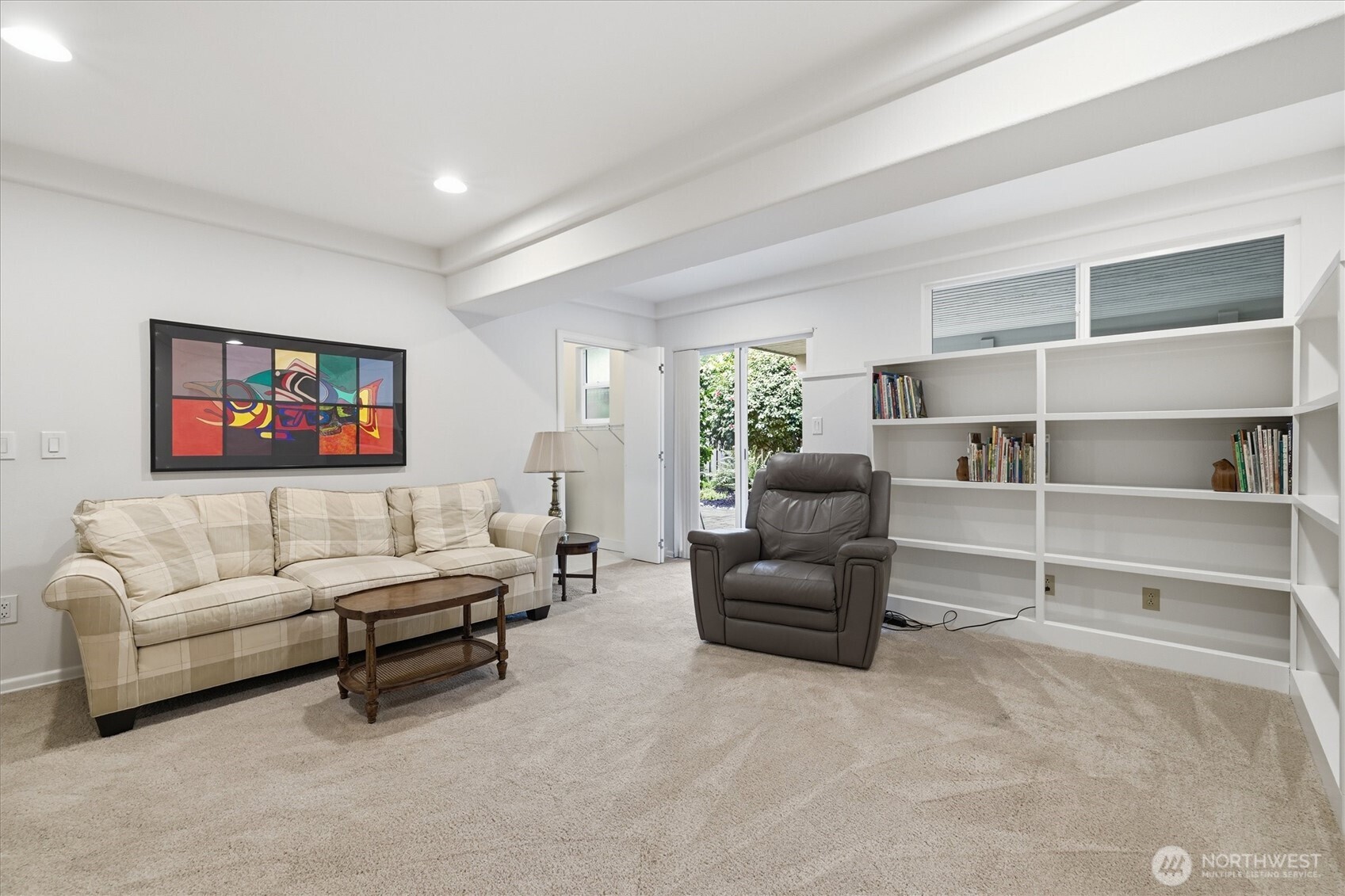 Enjoy the built-in book shelves and convenient access to the back yard.  Also pictured is a door into the adjacent laundry/mud room, the perfect spot to take off your muddy clothes when coming in from outside.