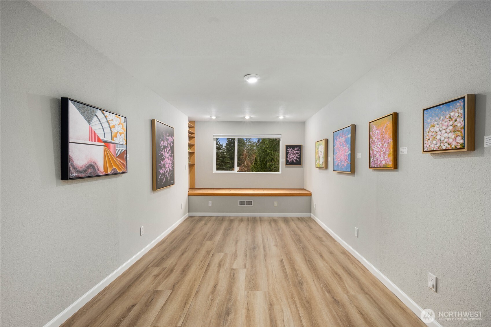 Spacious Murphy bed, bedroom/office  with built-in cabinetry, brand new floors, recessed lighting, and flexible space ideal for media, office, or guests.