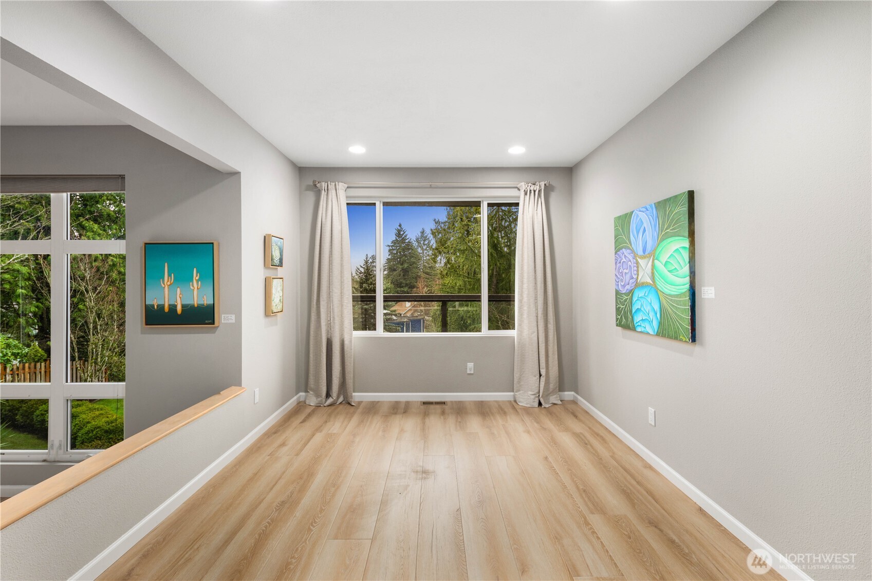 Clean, light-filled hallway with wide plank floors, recessed lighting, soft neutral tones, and a calm, contemporary flow throughout.