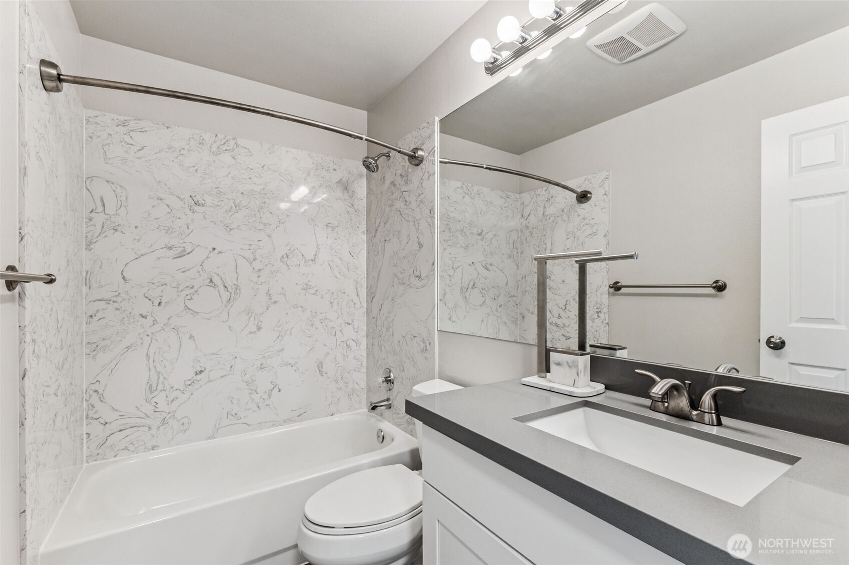 The primary bedroom has two closets, one to the left and a walk-in closet to the right.