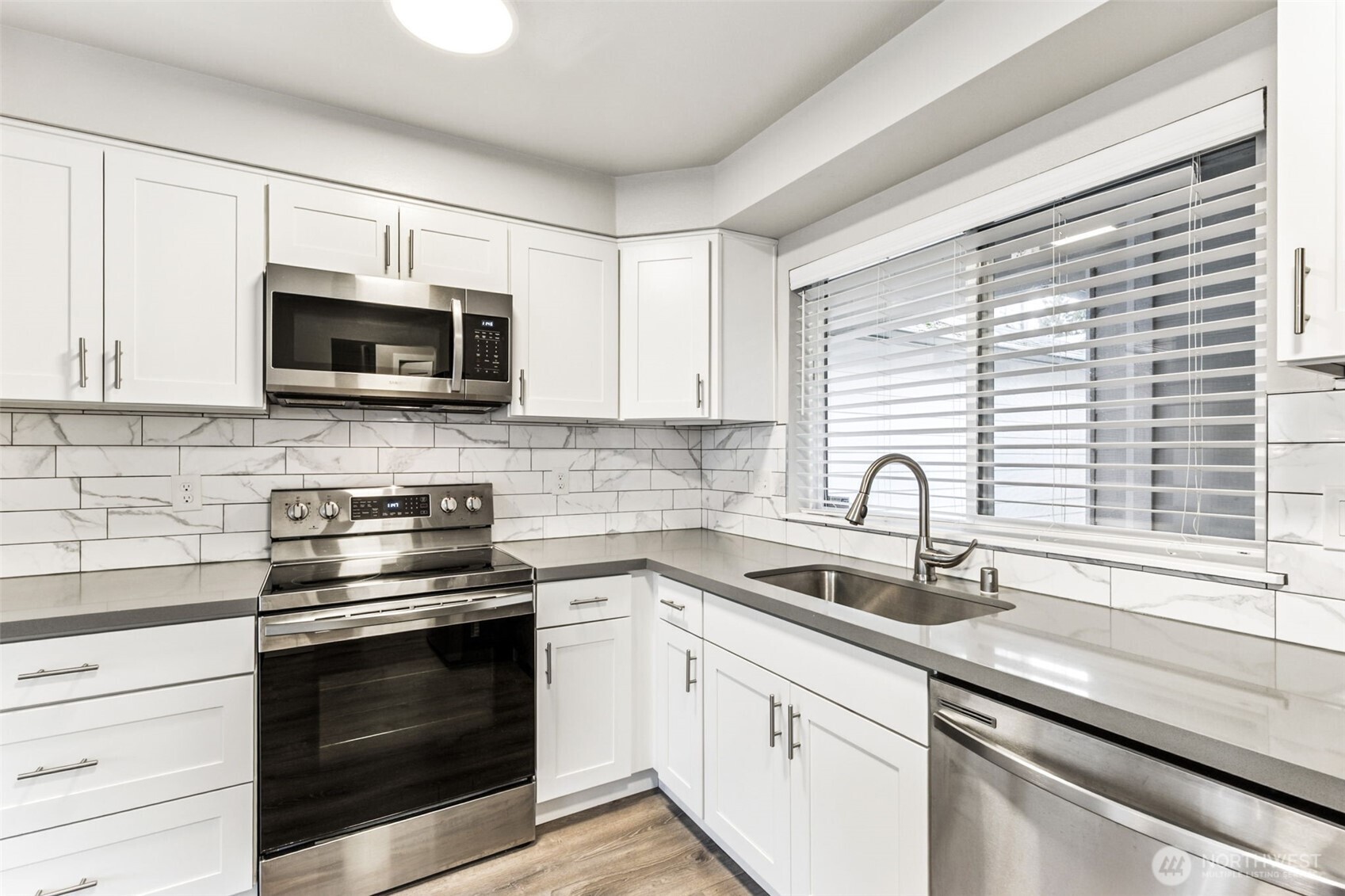 The updated kitchen has a convenient island where you can sit to eat or socialize.