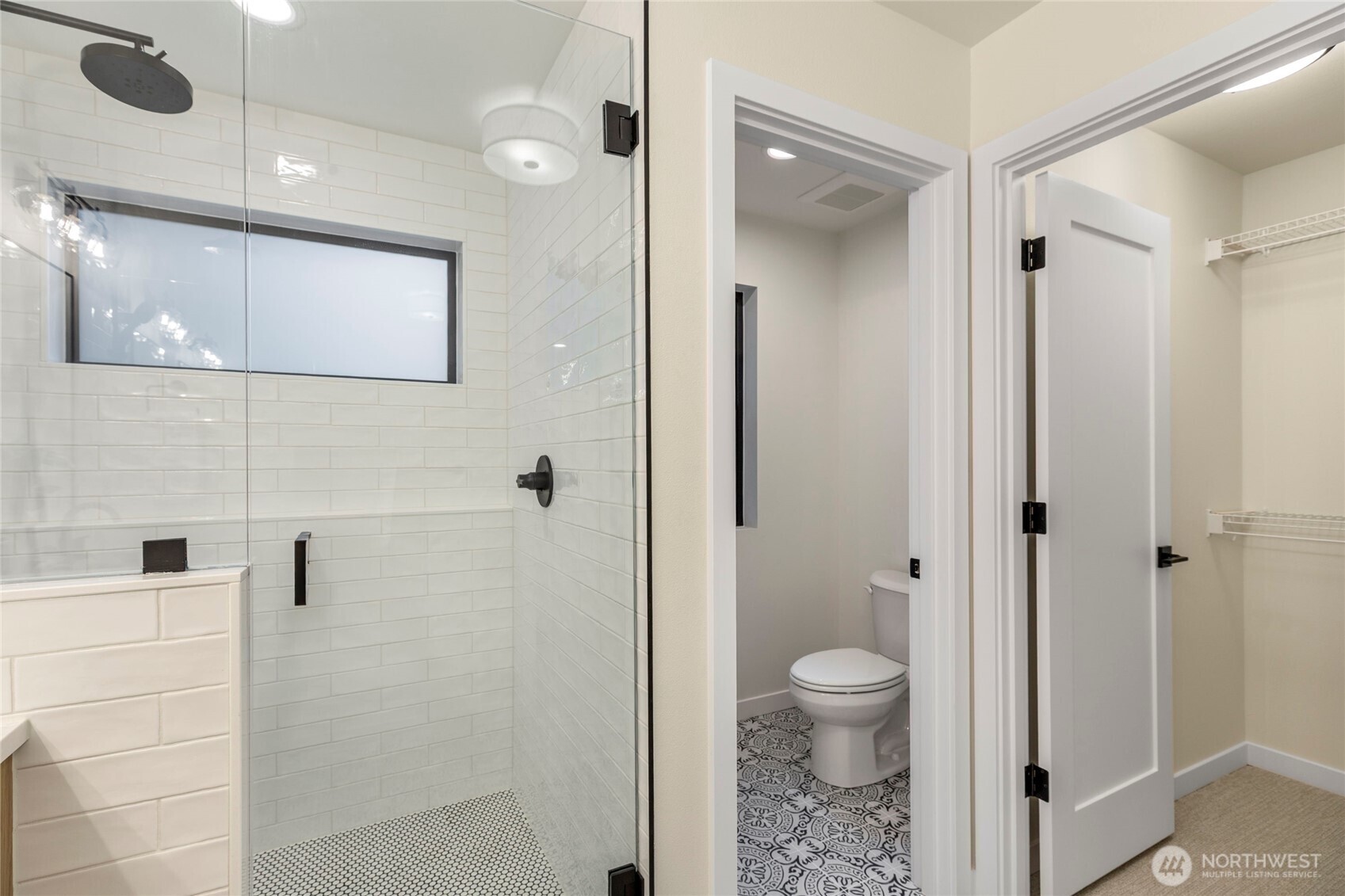 Primary bedroom walk-in closet access through the bathroom.