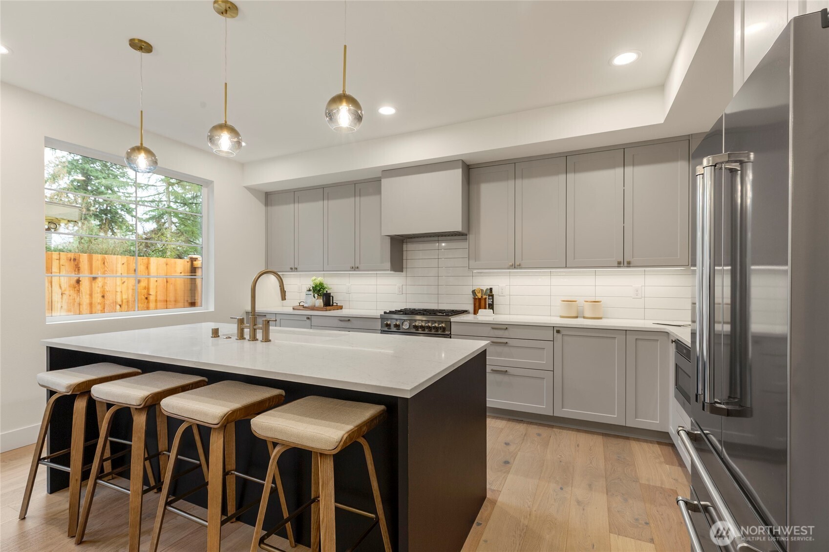 Kitchen featuring quartz countertop island with gold sink fixtures