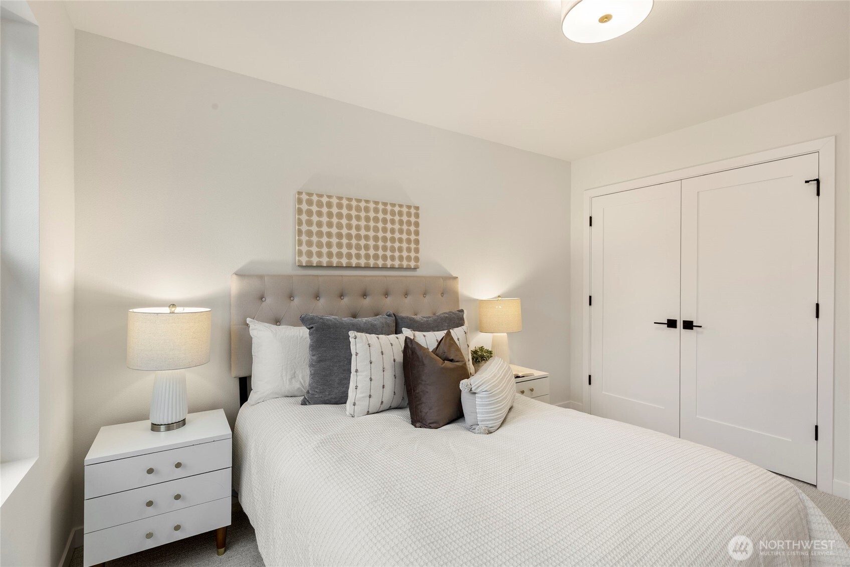 Walk-in closet behind double white doors.