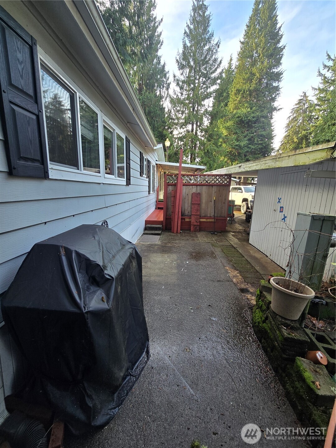 Another angle of patio area and storage shed off carport