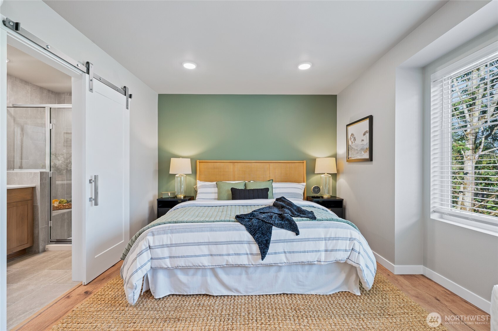 Primary suite with large bath finished with tile floor and tile shower surround from floor to ceiling. Dual sinks and quartz counters! Photos are of model home in the community.