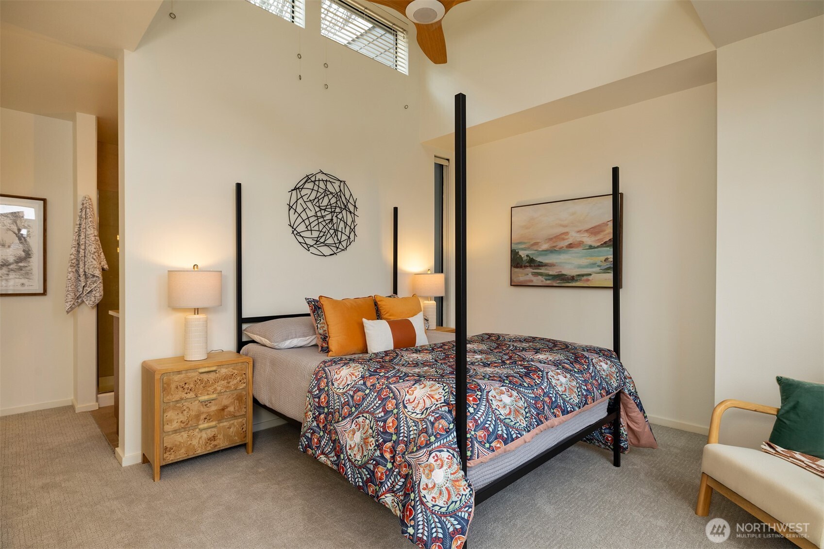 Primary bedroom ensuite with soaring ceilings.