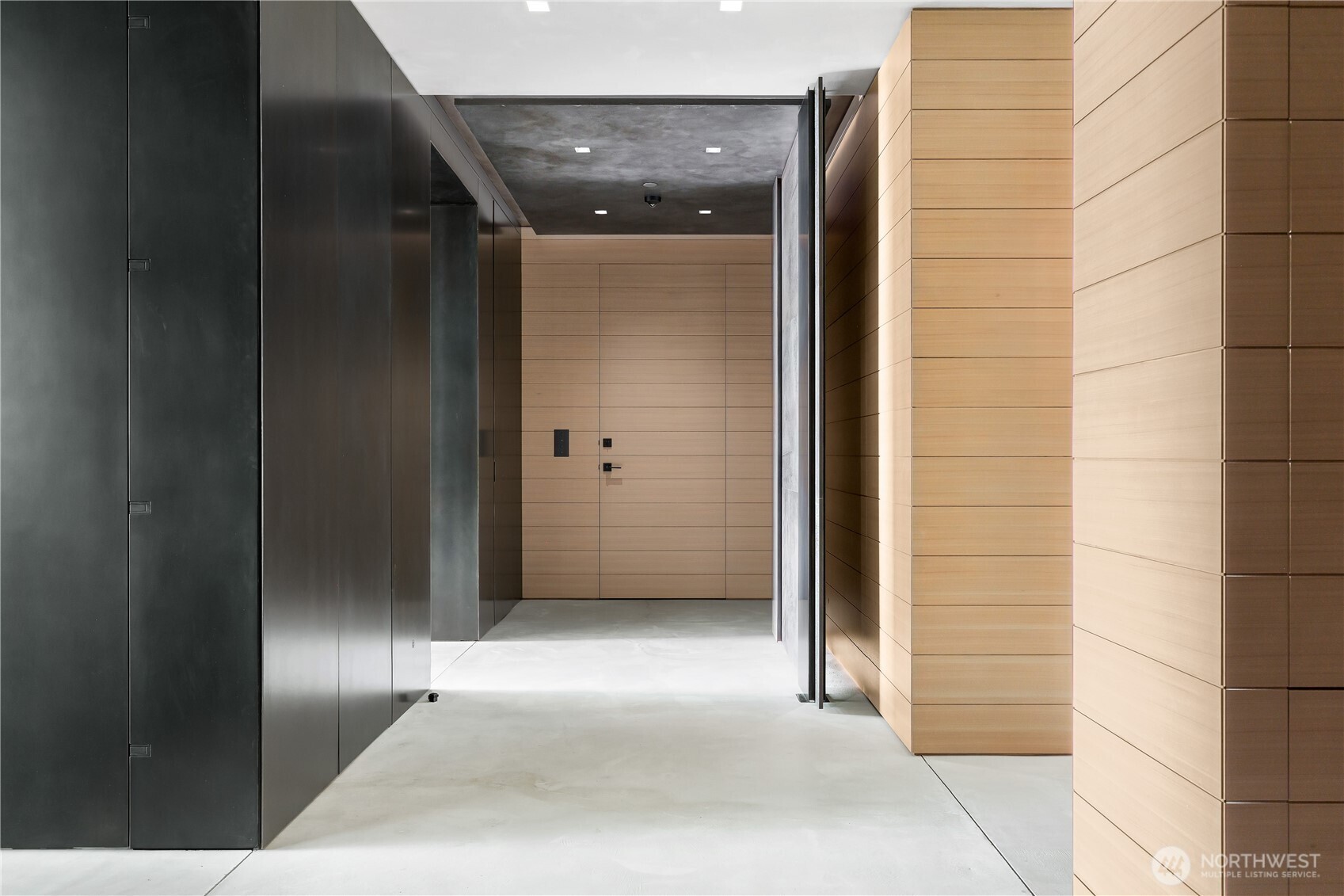 Grand front entry with impeccable case work, steel walls and doors accented by Venetian plaster walls and ceilings.