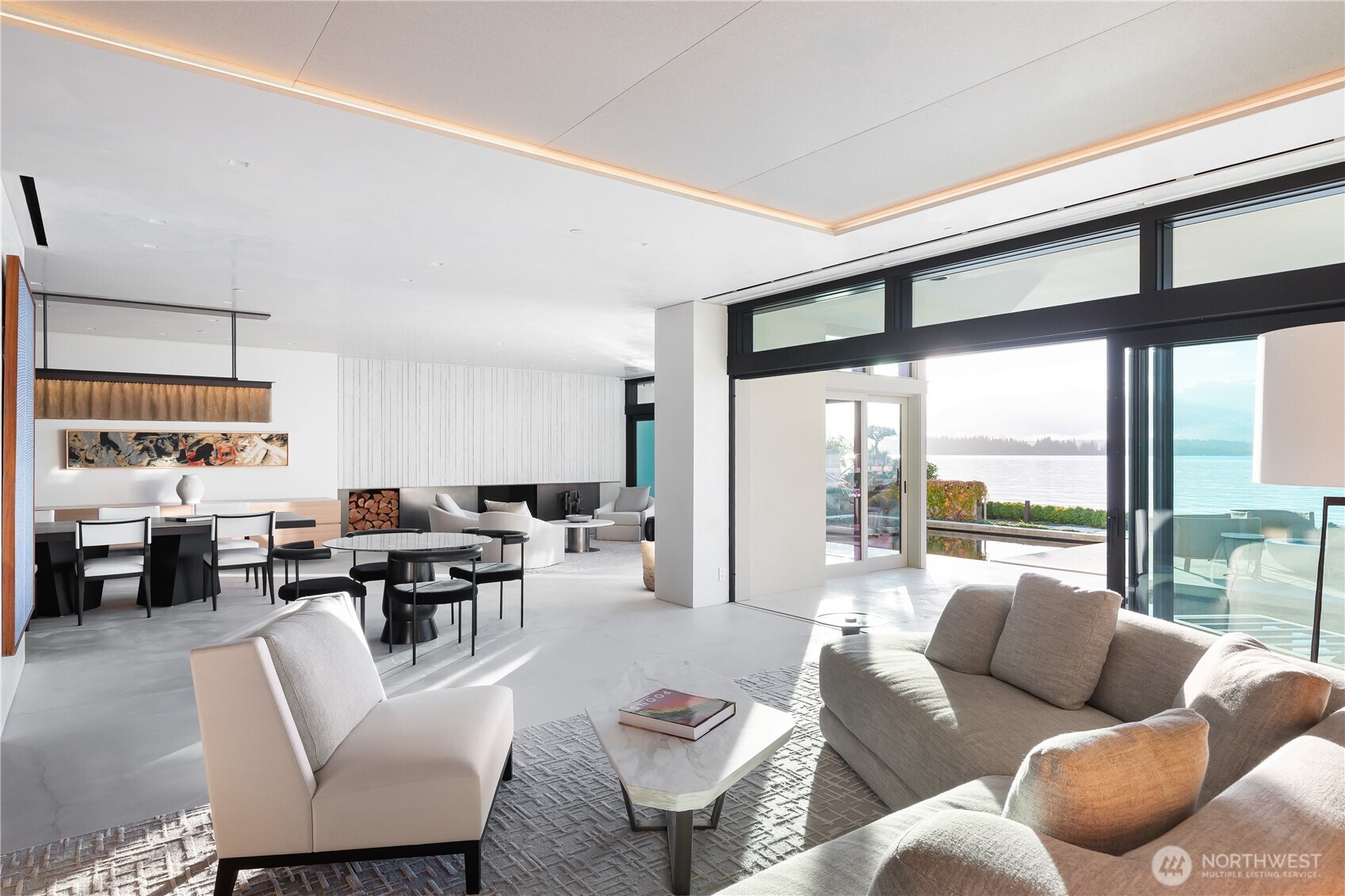 Living room area looking across to the dramatic Bronze and cast concrete fireplace. Spaces feature both radiant heat, forced air and A/C as well as several acoustically treated conversation areas and invisible built-in audio speakers throughout.