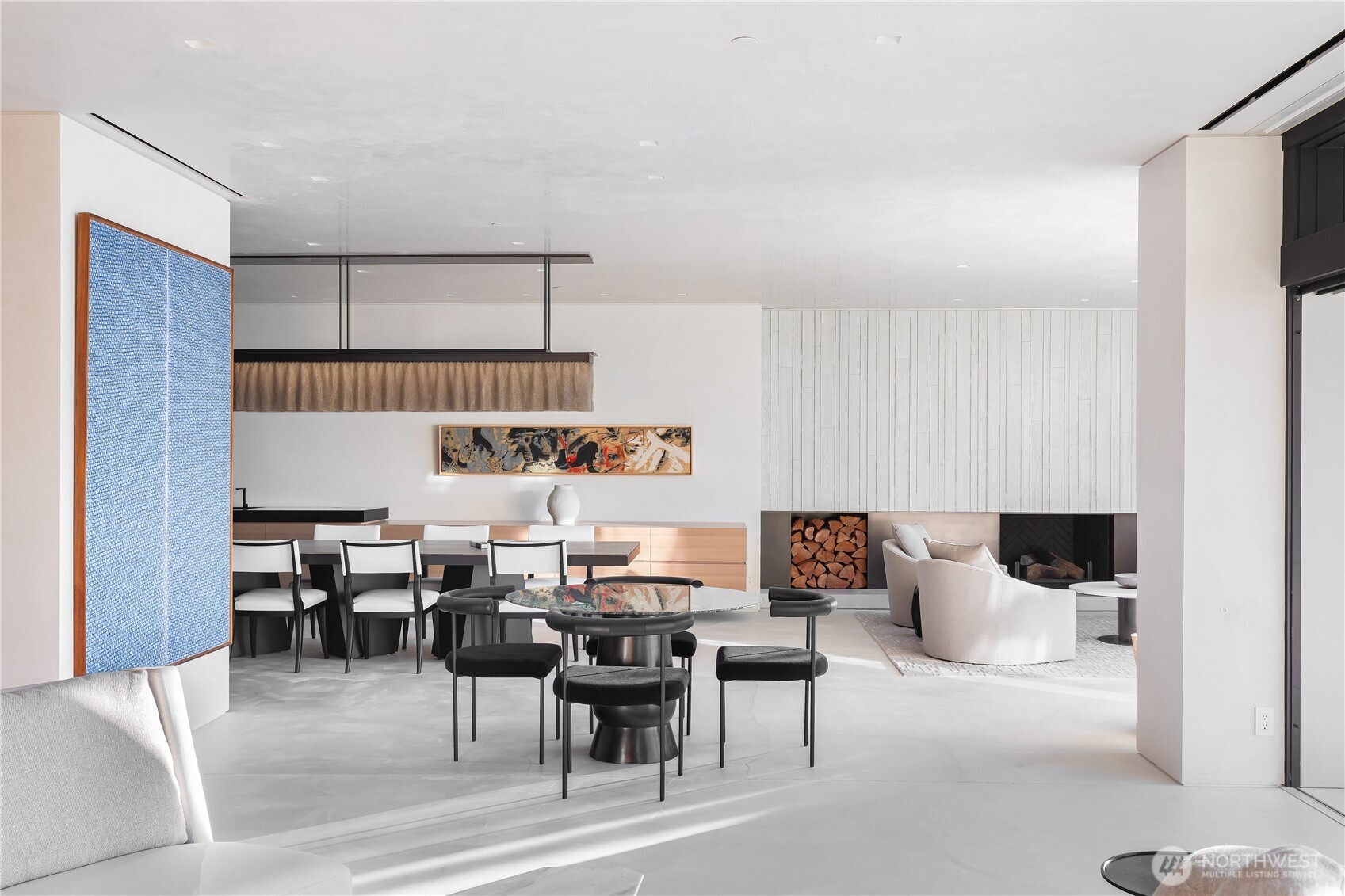 Breakfast space, West end of the purpose built dining table plus the conversation area with wood burning fireplace.