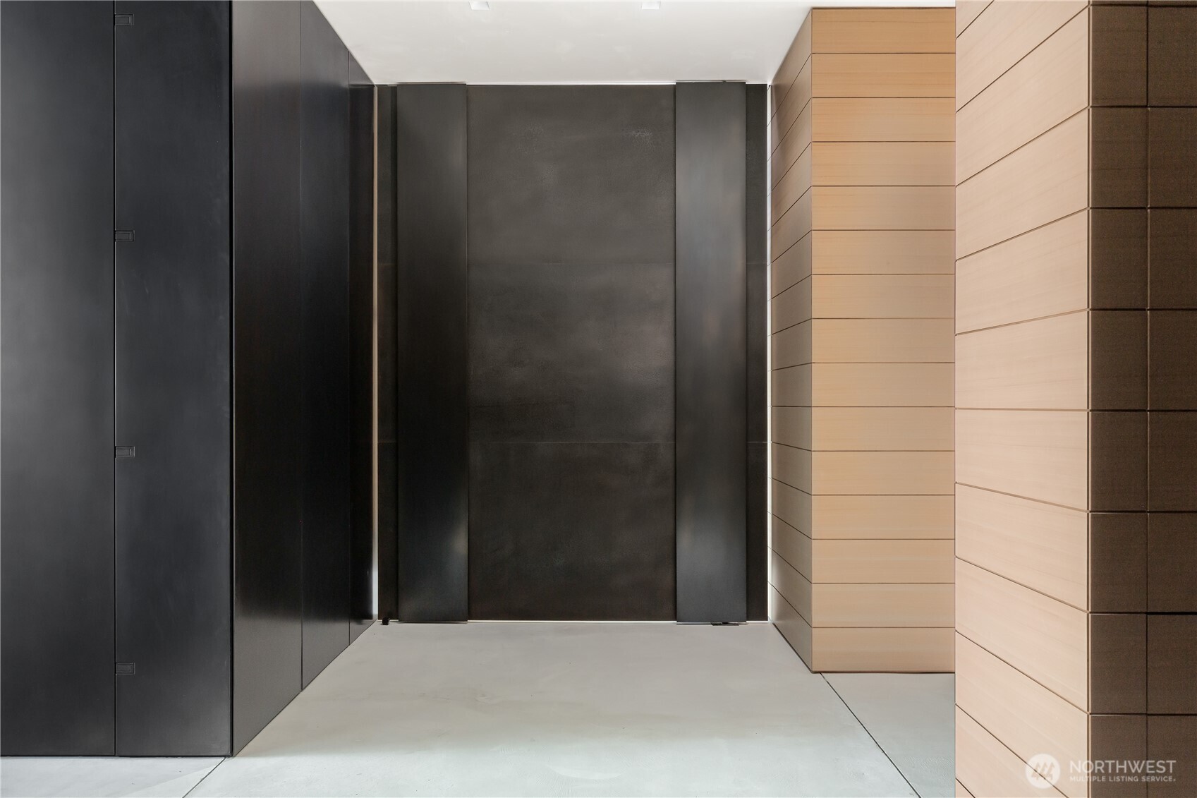 Two ton reclaimed steel pivot wall directs flow into entertaining spaces... Functional Art.