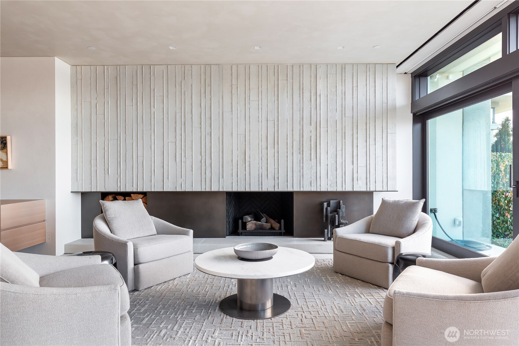 Modern formed concrete and Bronze fireplace. Gas fired and wood burning.