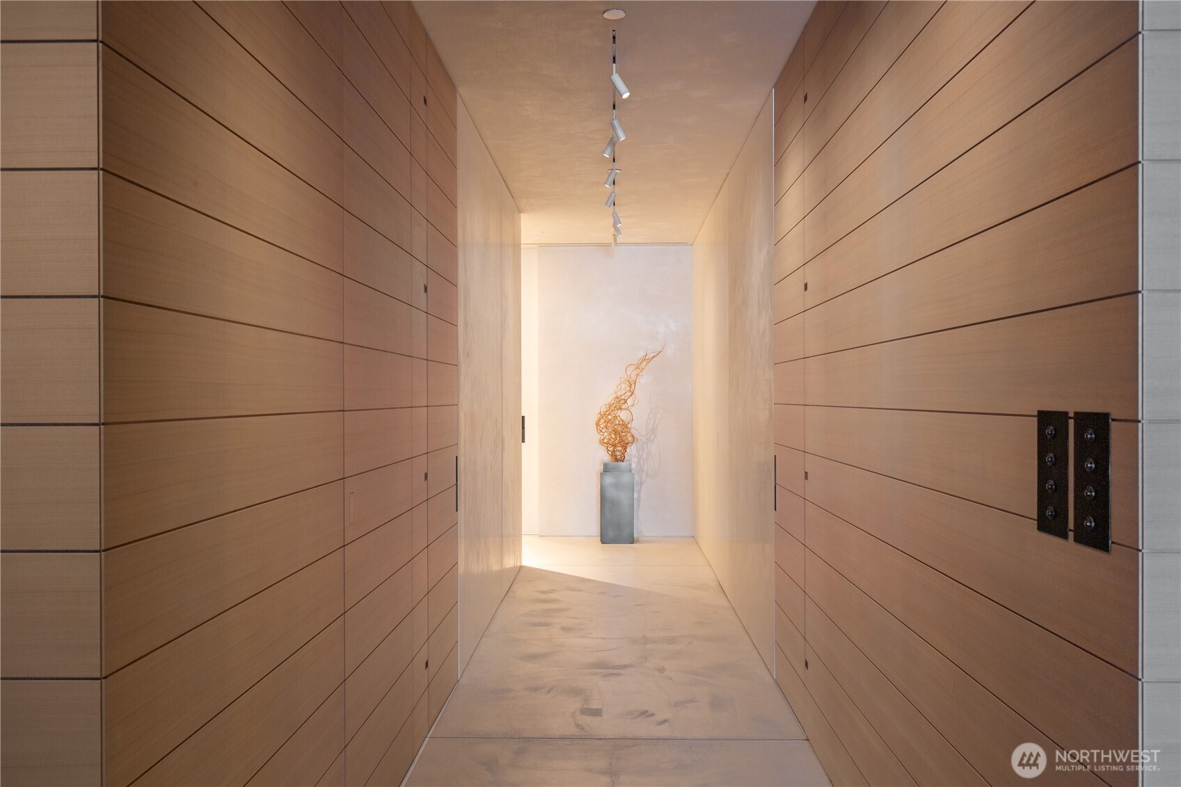 Dramatic main hallway with hidden access to a three quarter bathroom, flex guest space and primary suite.