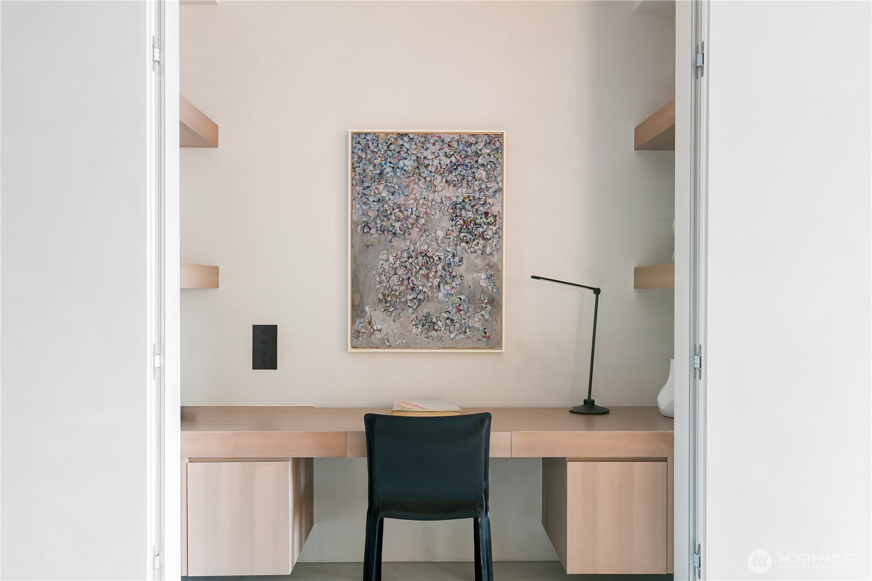 Convenient home office and storage tucked away behind hidden doors.