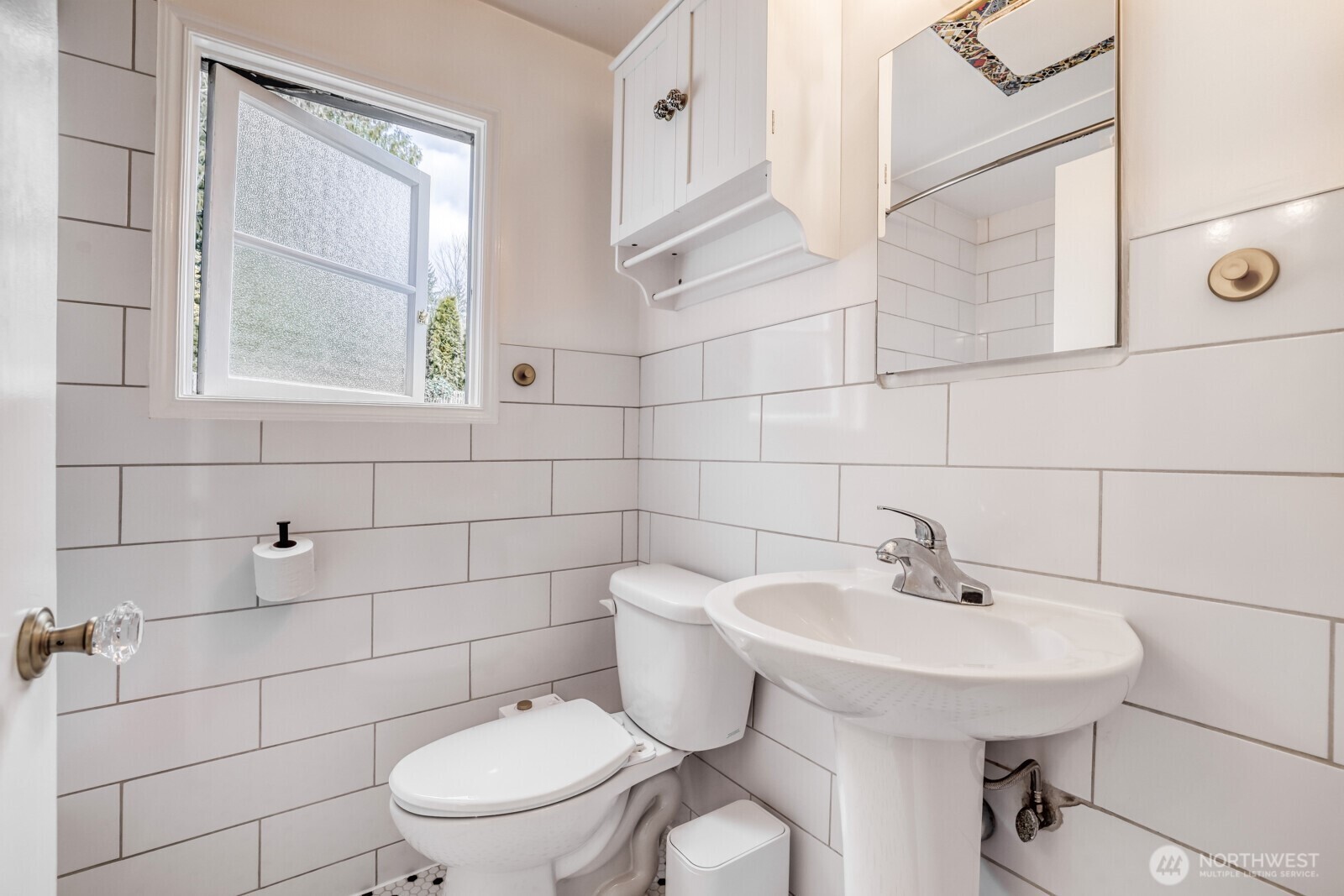 Full tub with subway tiles.