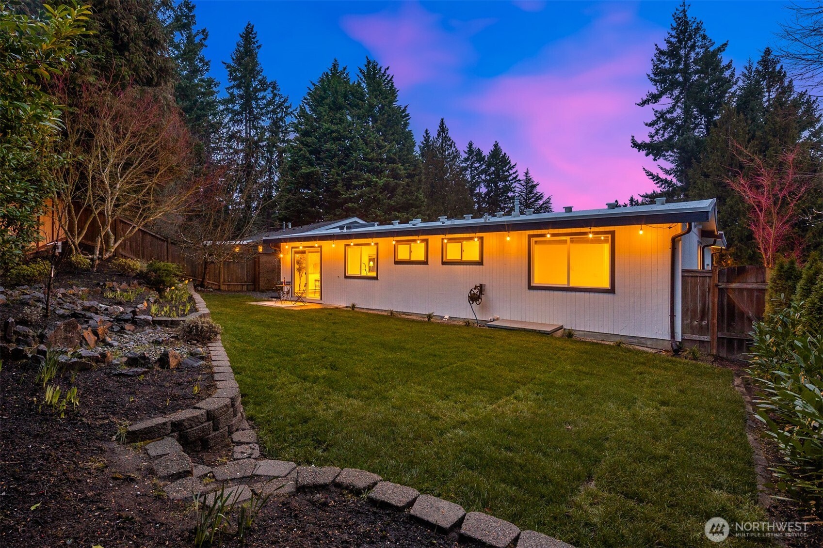 Updated backyard: Pressure cleaning on the retaining wall, new sod, new plantings, new fence.