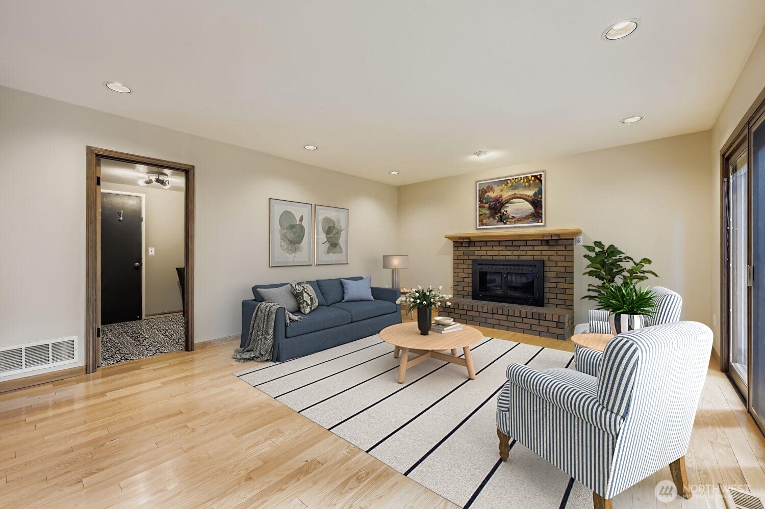 The family room features a gas fireplace with an air circulating fan and beautiful gleaming hardwood floors.