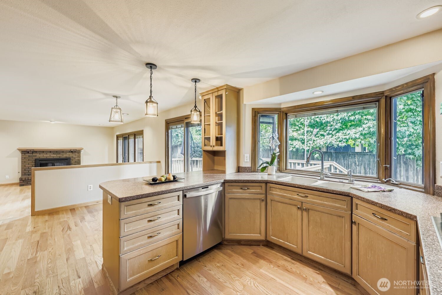 The spacious kitchen continues into the breakfast area and one step down to the family room. Both rooms have Pella sliding doors that access the deck and backyard.