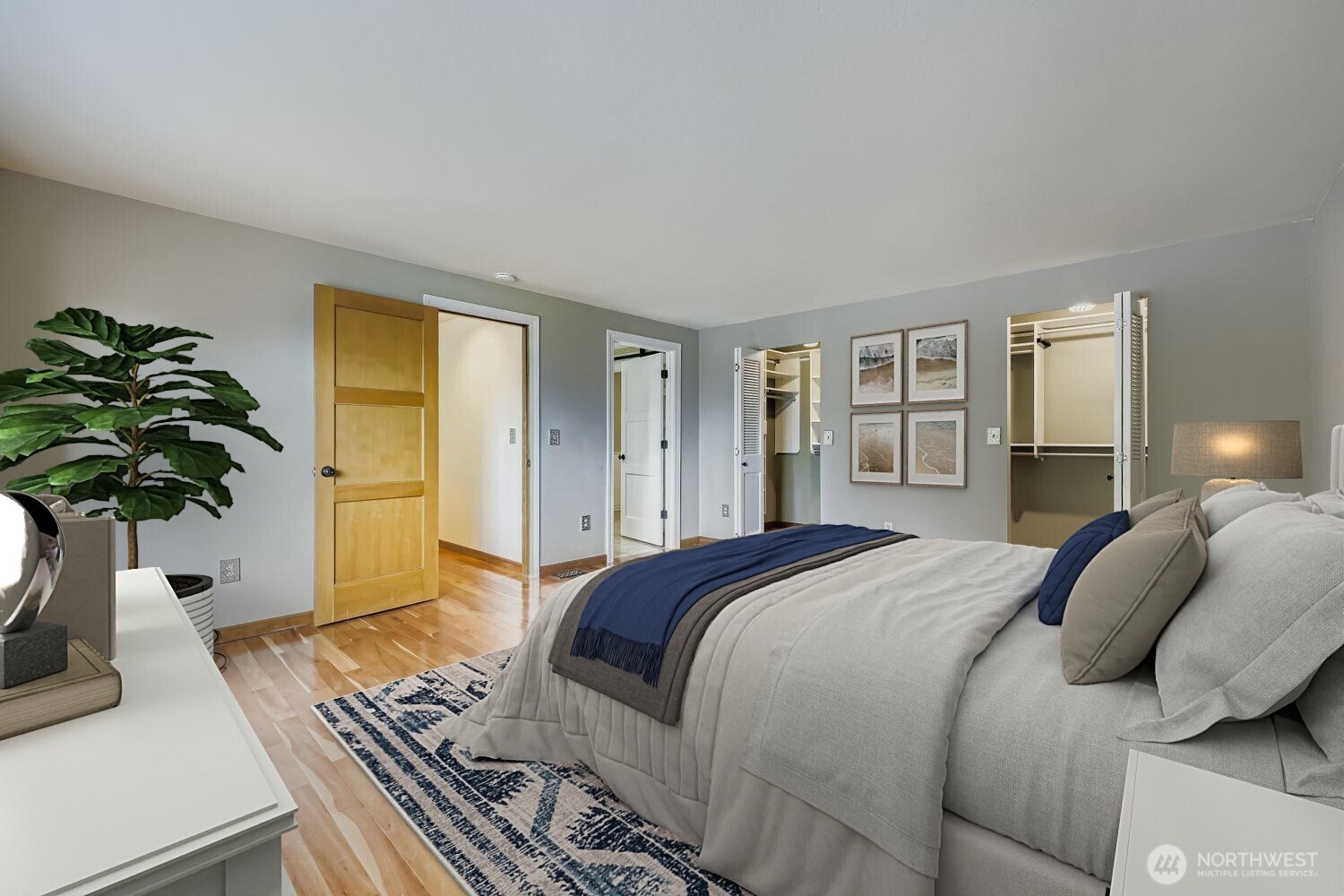 Hardwood flooring continues into the Primary Suite and the other 3 bedrooms. Two separate doors lead into the large custom closet with organizers.