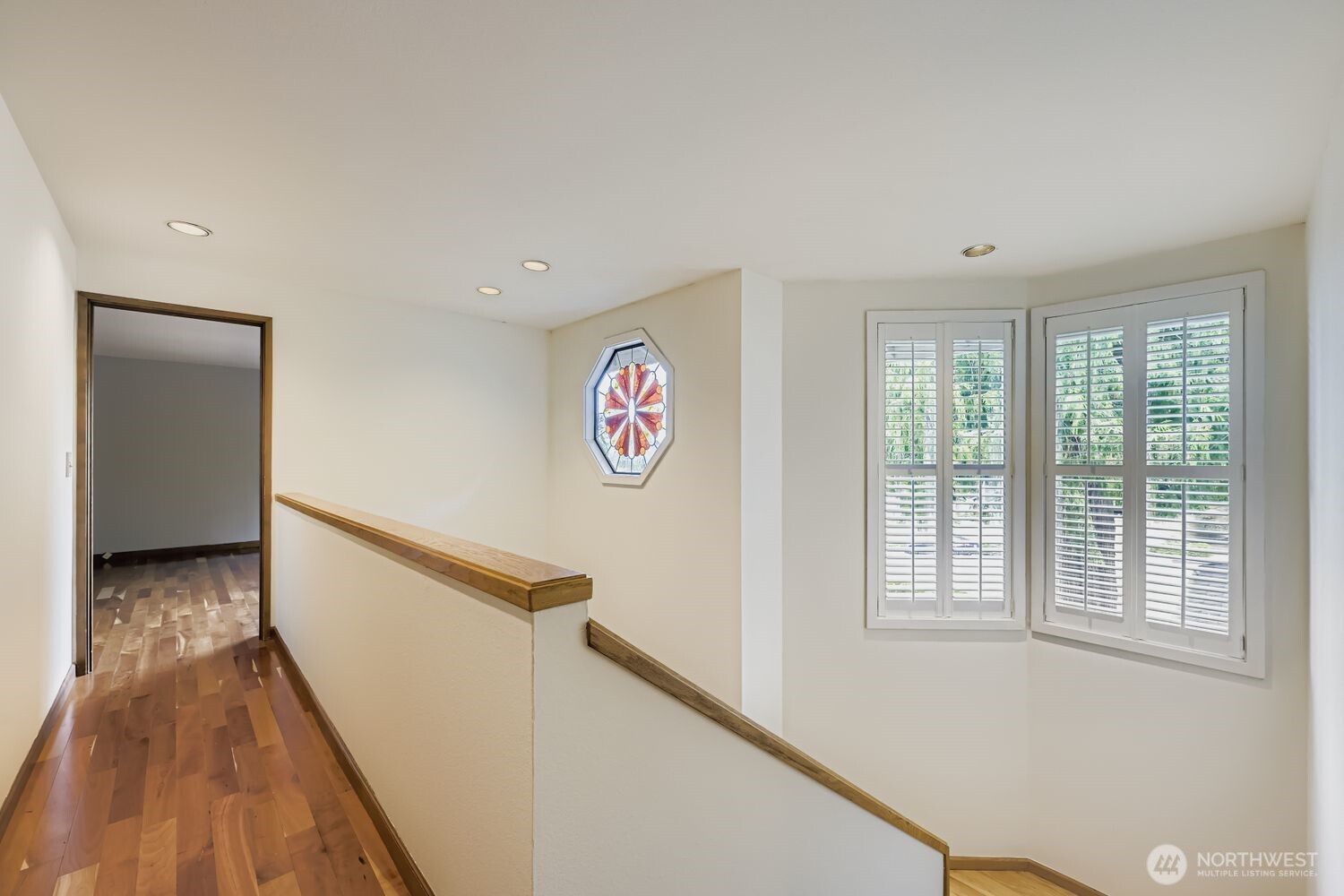 Enter the Primary Suite on one end of the home down the hallway with its hardwood floors. The other 3 bedrooms and full bath are at the other end, creating excellent separation of space.