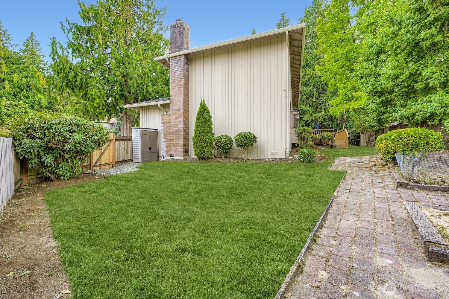 From the east side of the yard, you'll find a small work shed, brick pathways, raised gardens and a new gate and fence.