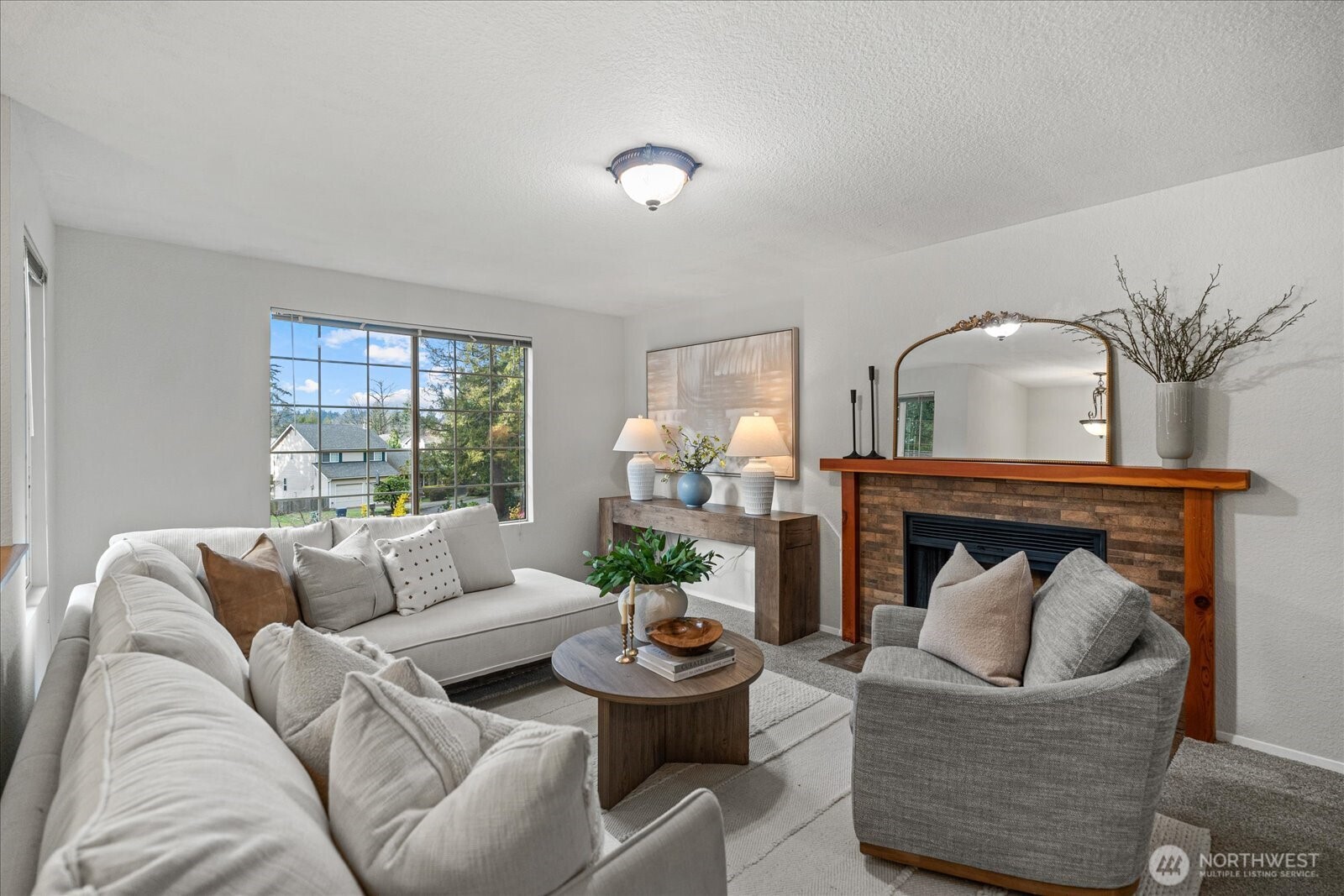 The living room seamlessly connects to the dining room and kitchen for easy every day living and entertaining with access to the deck just beyond, making it perfect for extended gatherings outdoors.