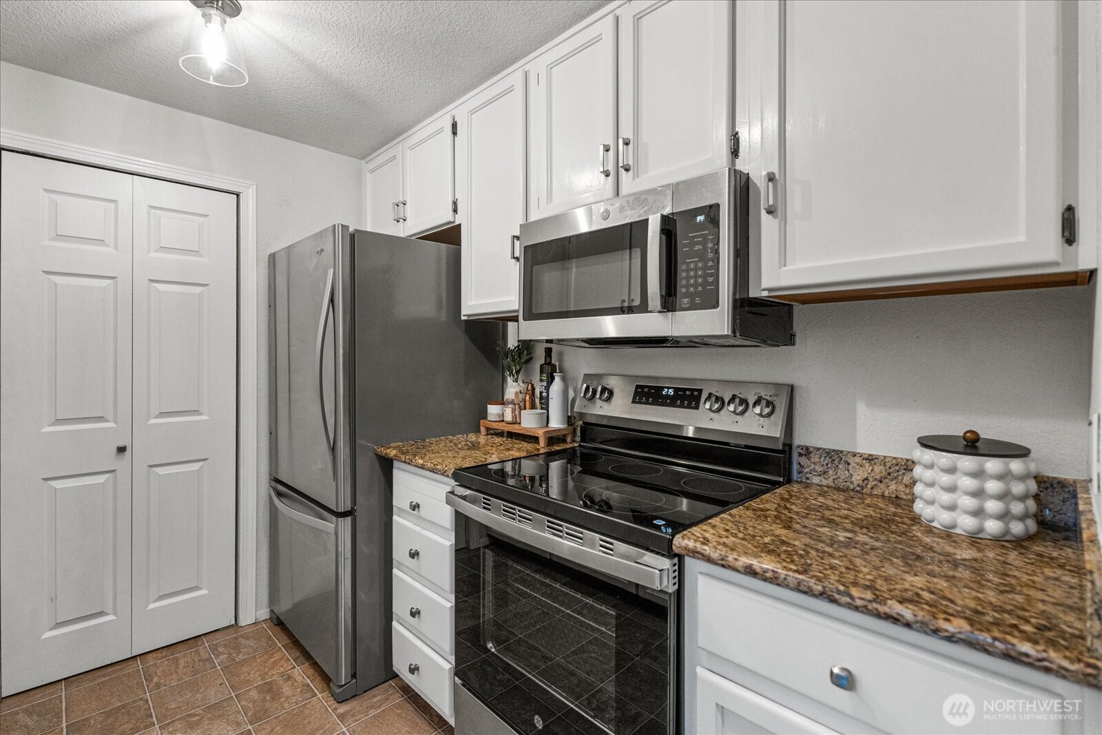 Conveniently located off the dining room, the kitchen features a spacious pantry, granite countertops, and all-new stainless steel appliances.
