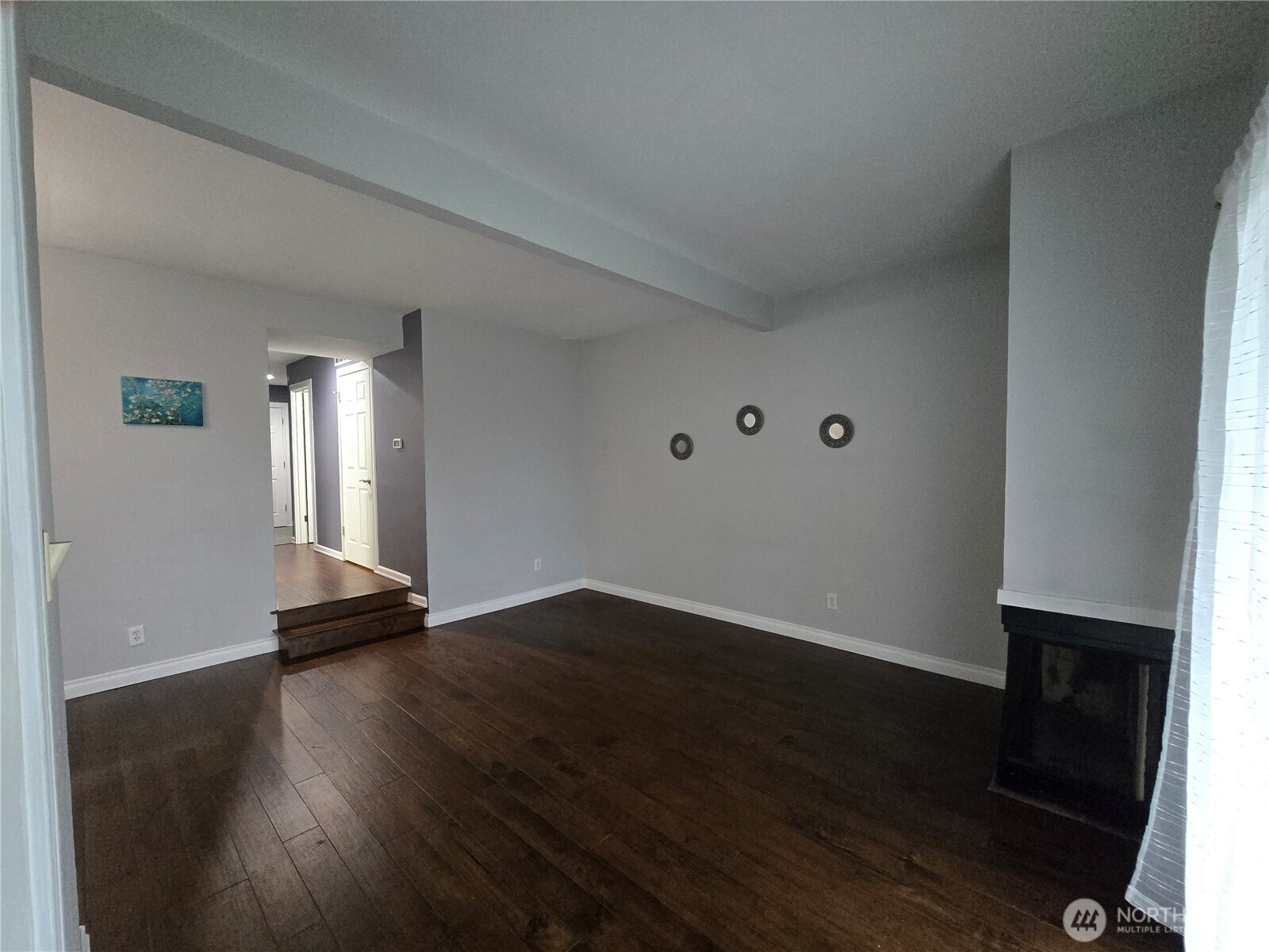 Vuiew from dining into Livingroom with corner fireplace