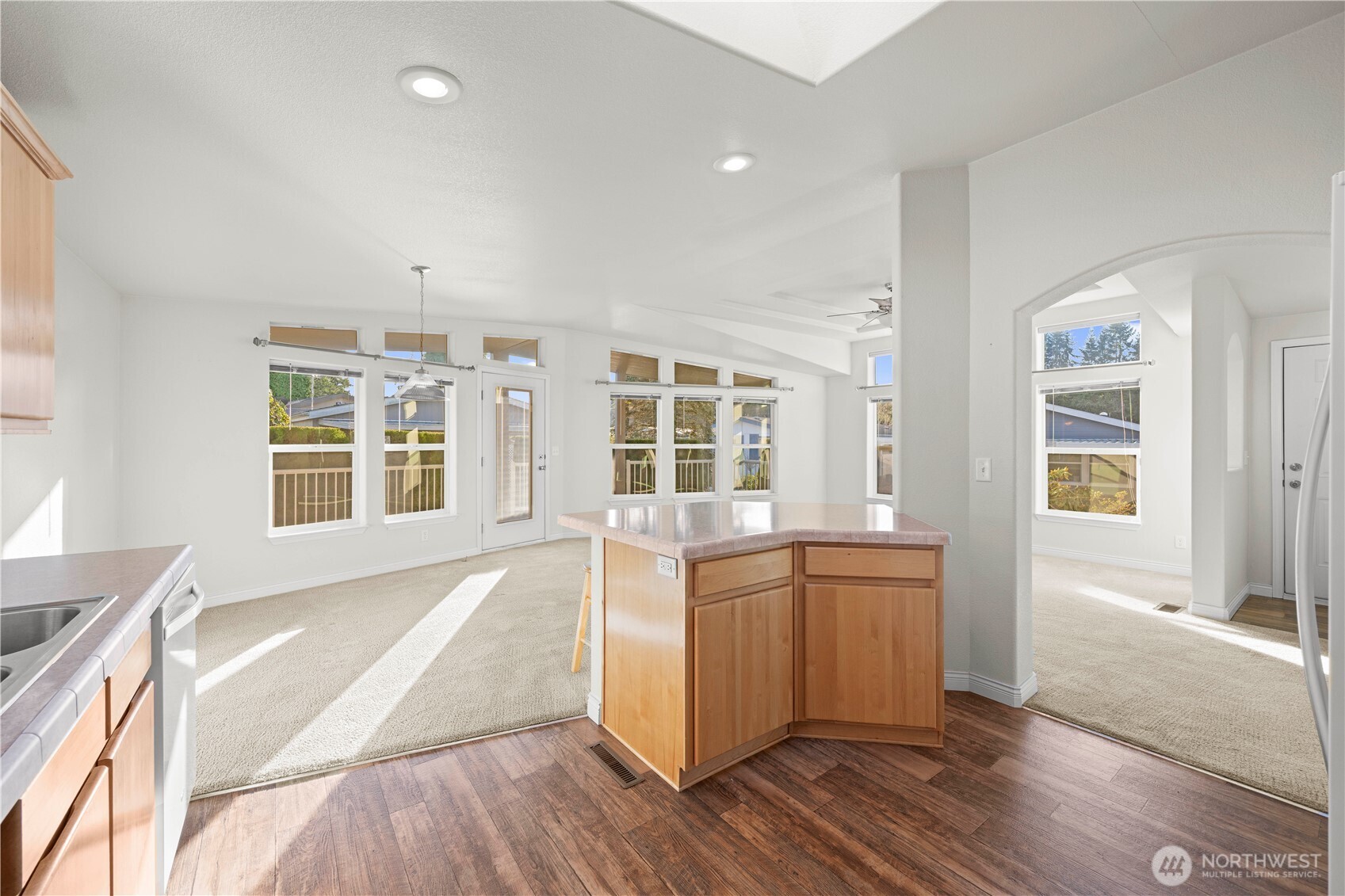 Hardwood-style flooring adds a touch of elegance, while the open layout flows seamlessly into the dining and living areas.