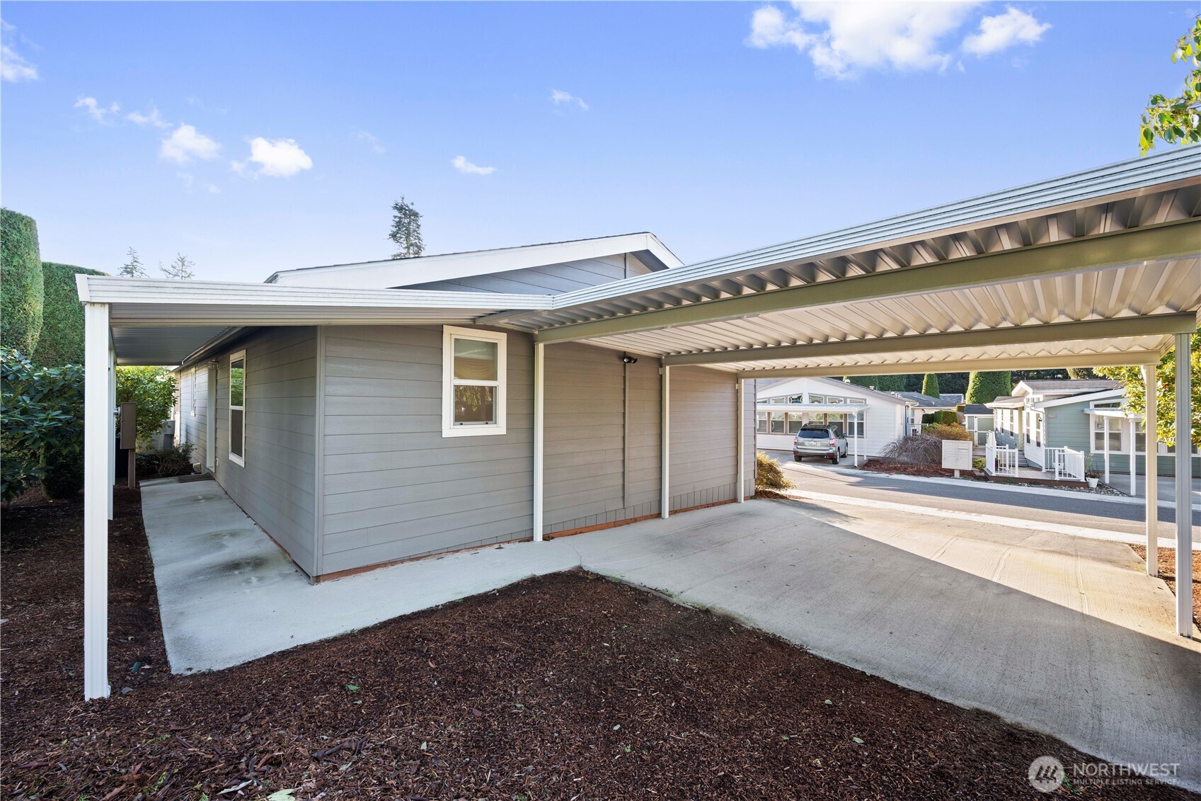 Enjoy the ease of a covered pathway connecting the carport to the back door, perfect for comfort and convenience rain or shine.