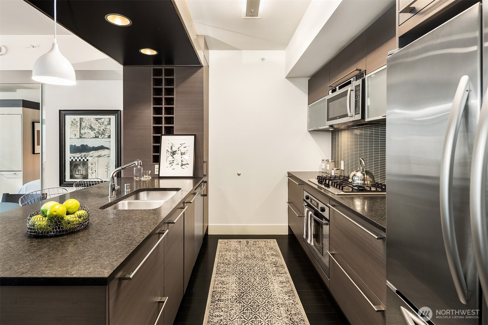 Sleek finishes in the open, galley style kitchen