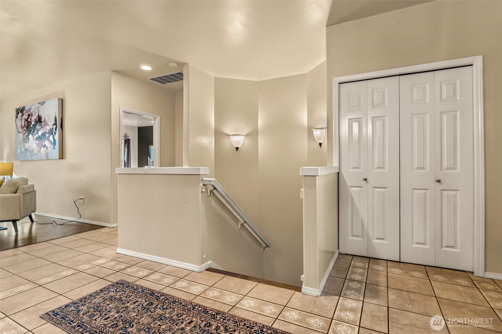 Peaceful backyard overlooking a lush garden and small open field.