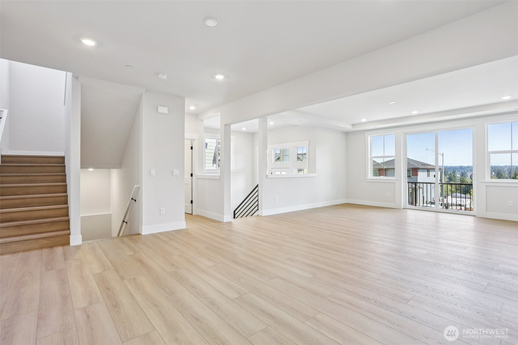 A grand entry invites a warm welcome into the expansive great room/dining room on the main level