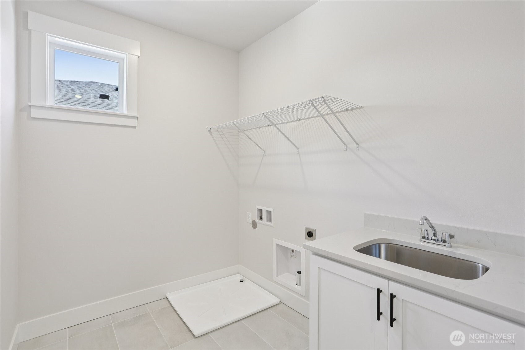 Large laundry room on 3rd level with utility sink.  This home will come with GE front load washer/dryer.