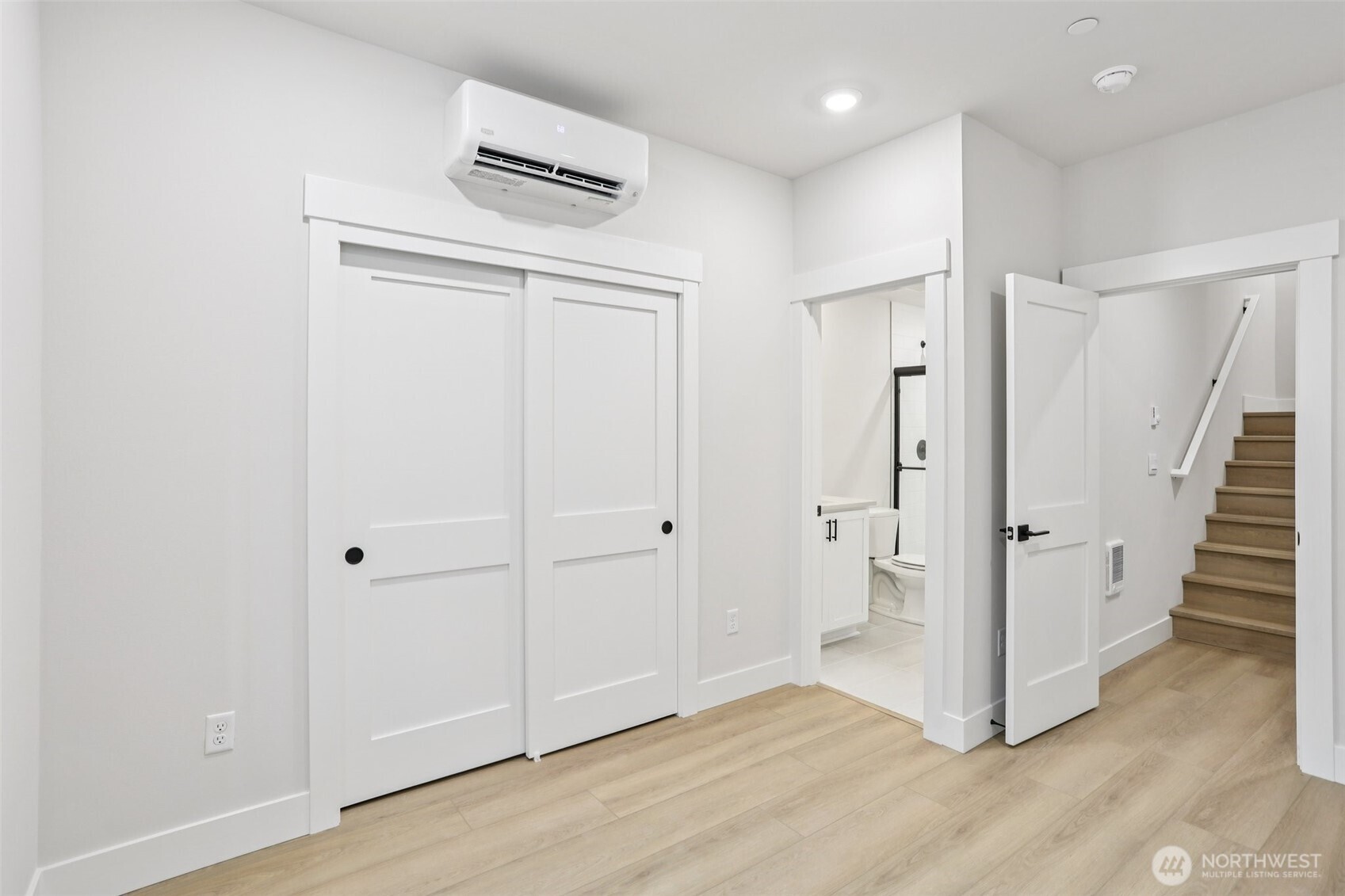 Stairs to lower level highlight entry into 5th bedroom perfect for a private guest suite or potential office