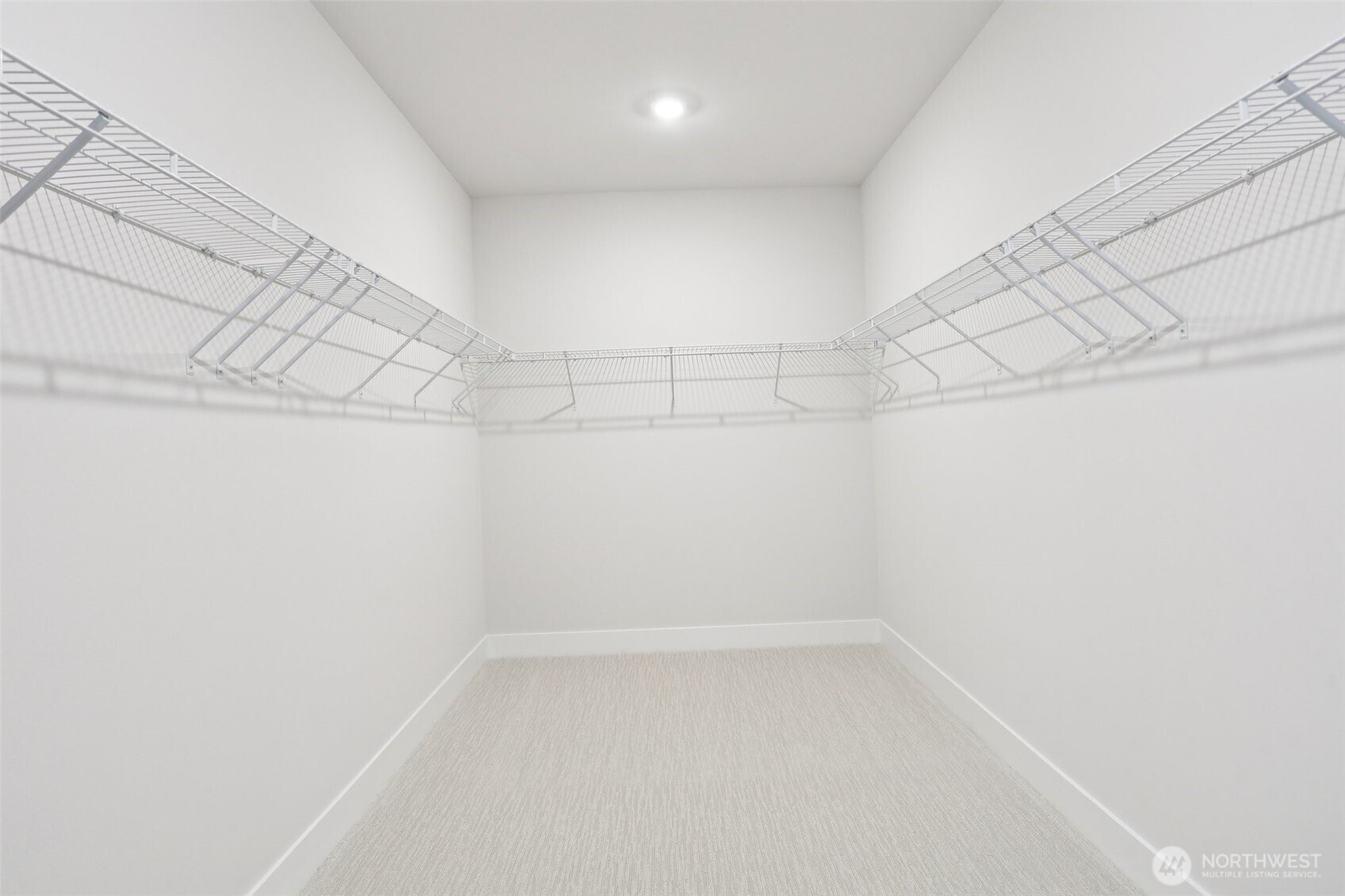 An oversized primary walk-in closet provides endless storage possibilities.