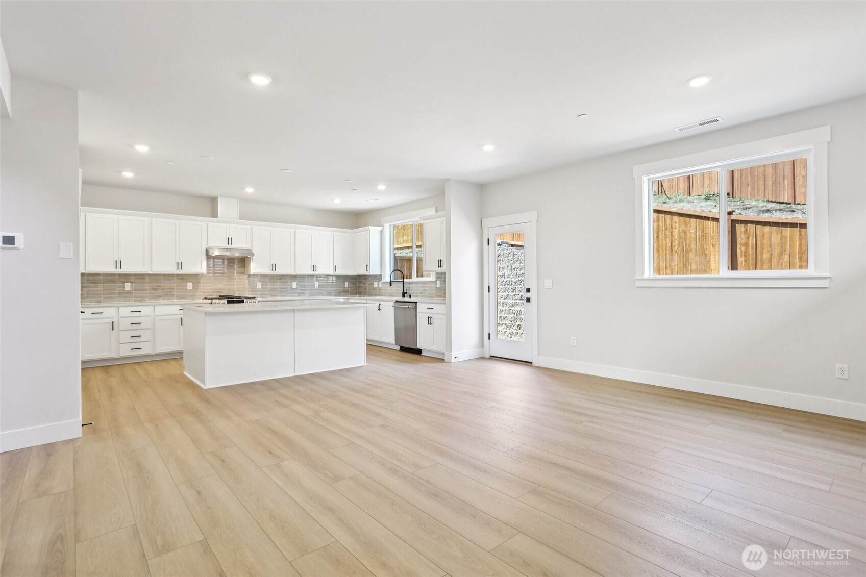View from family into kitchen with access to fully landscaped rear yard.