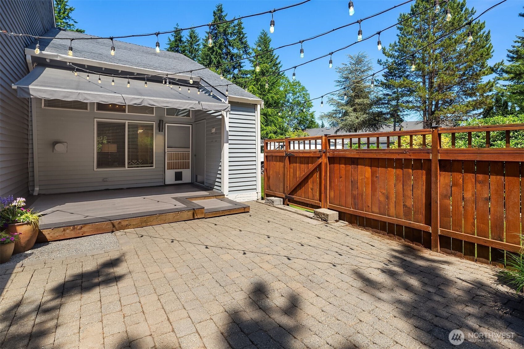 Back patio virtually staged.  Imagine the possibilities of creating your own space.  Yard comes with Italian lights.