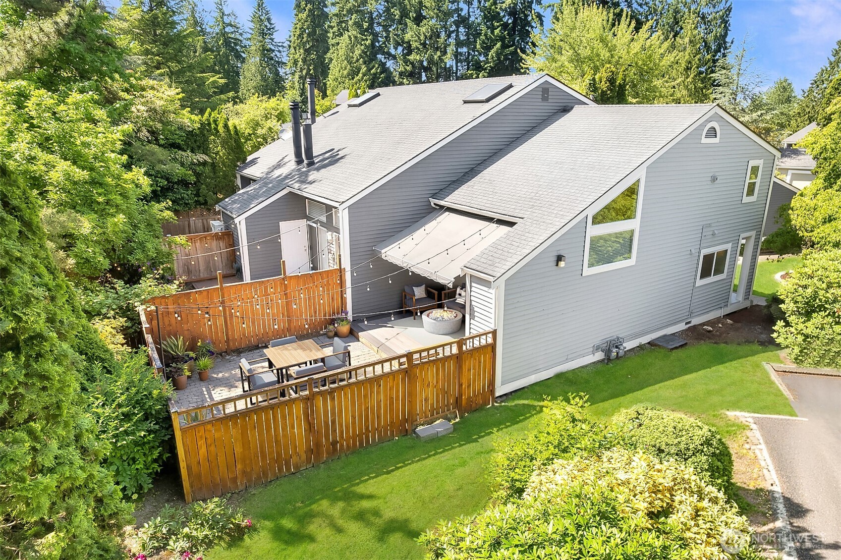 Sun filled lot view of townhouse with yard.  New roof place on unit in Fall of 2025.