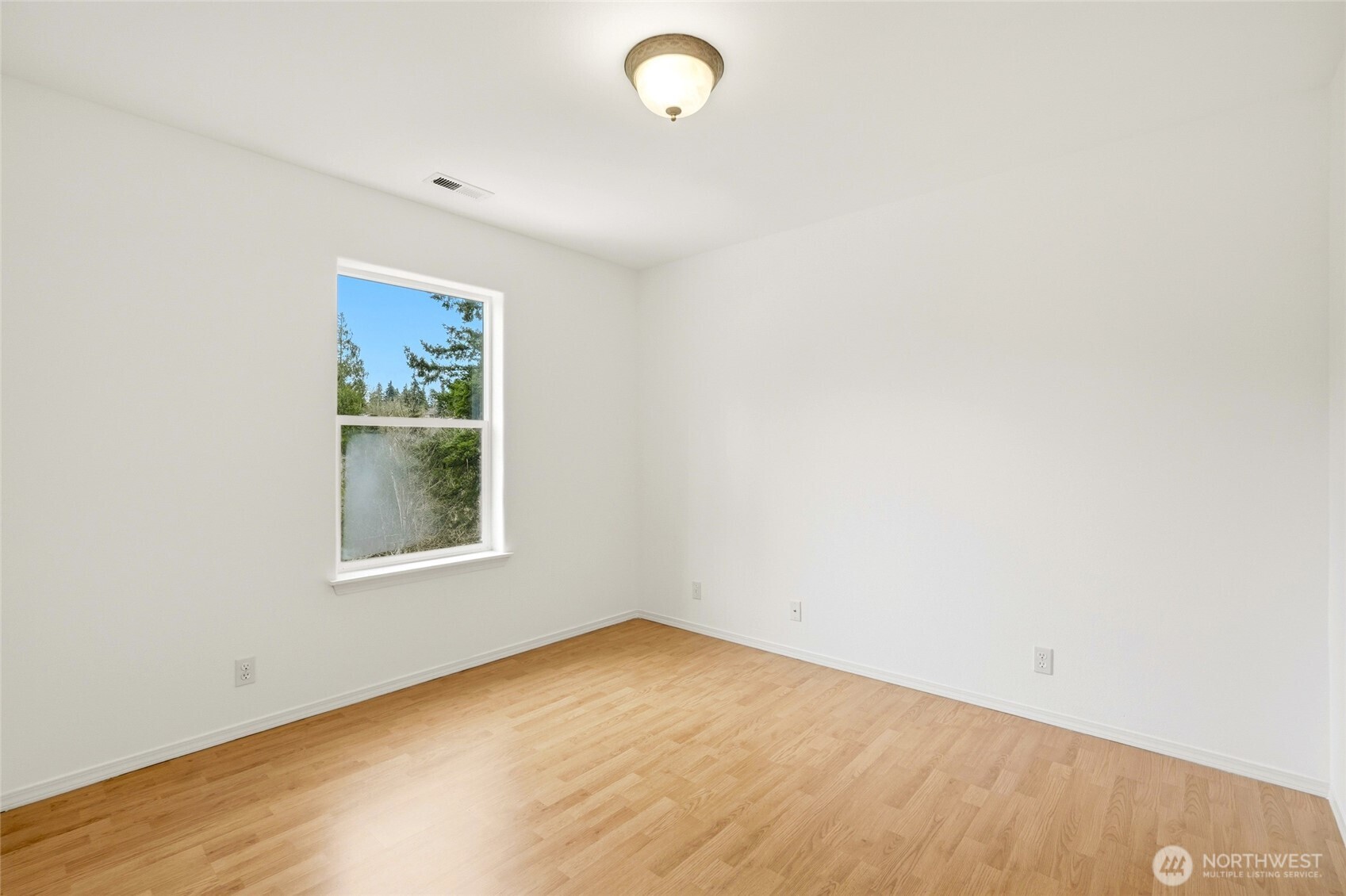 Bright, comfortable secondary bedroom that's perfect for guests, hobbies, or workspace. Convenient access to full hall bathroom.