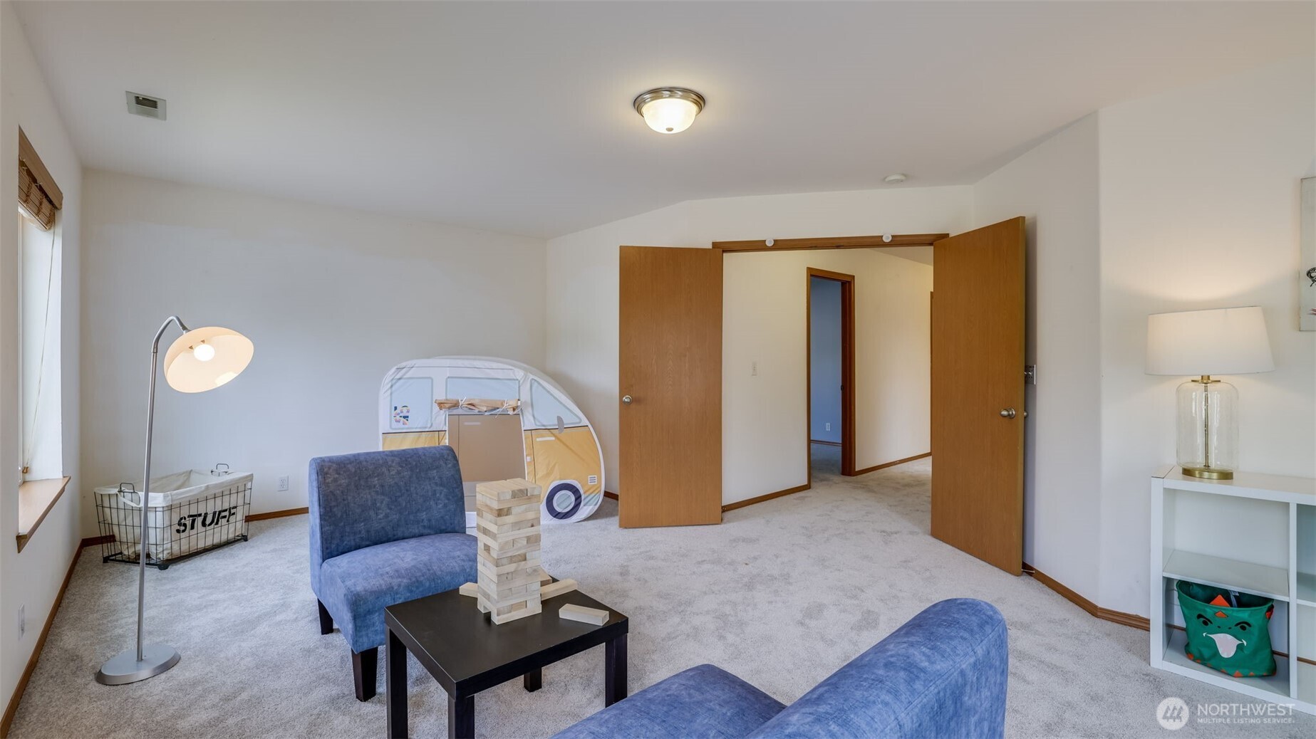 Behind double doors, this spacious fourth bedroom offers room for a cozy seating area, stylish decor, storage baskets, or any personal touches to make it your own retreat