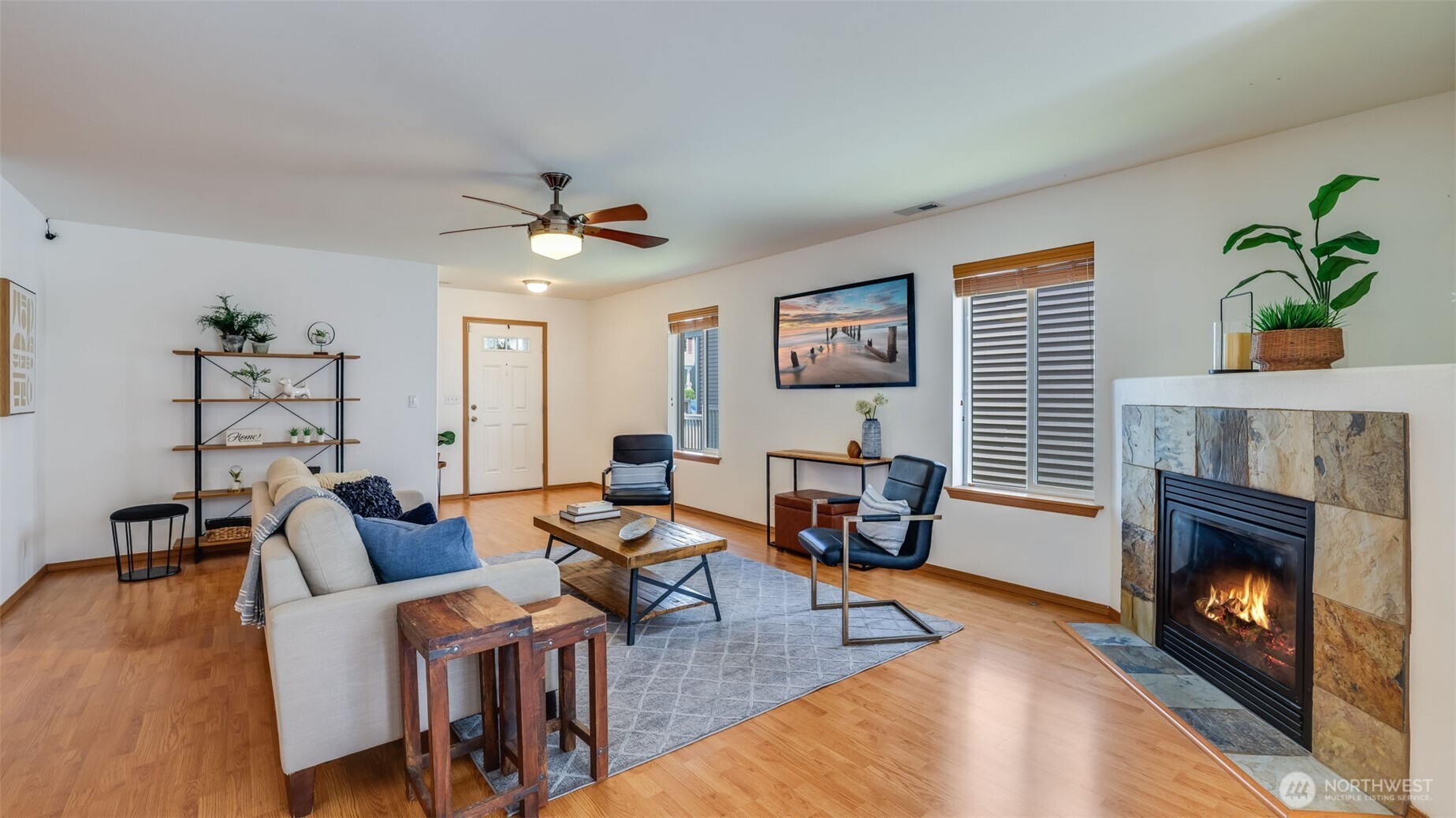 This bright and inviting living room features stunning wood floors that set the tone for the open-concept layout, offering seamless flow throughout the space