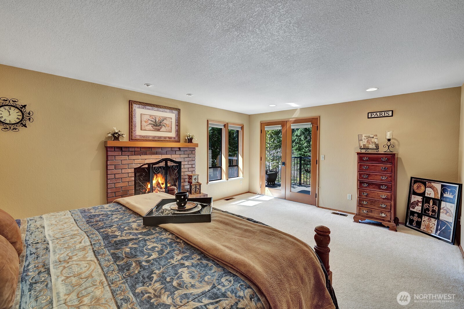 Primary bedroom features French doors onto private deck space