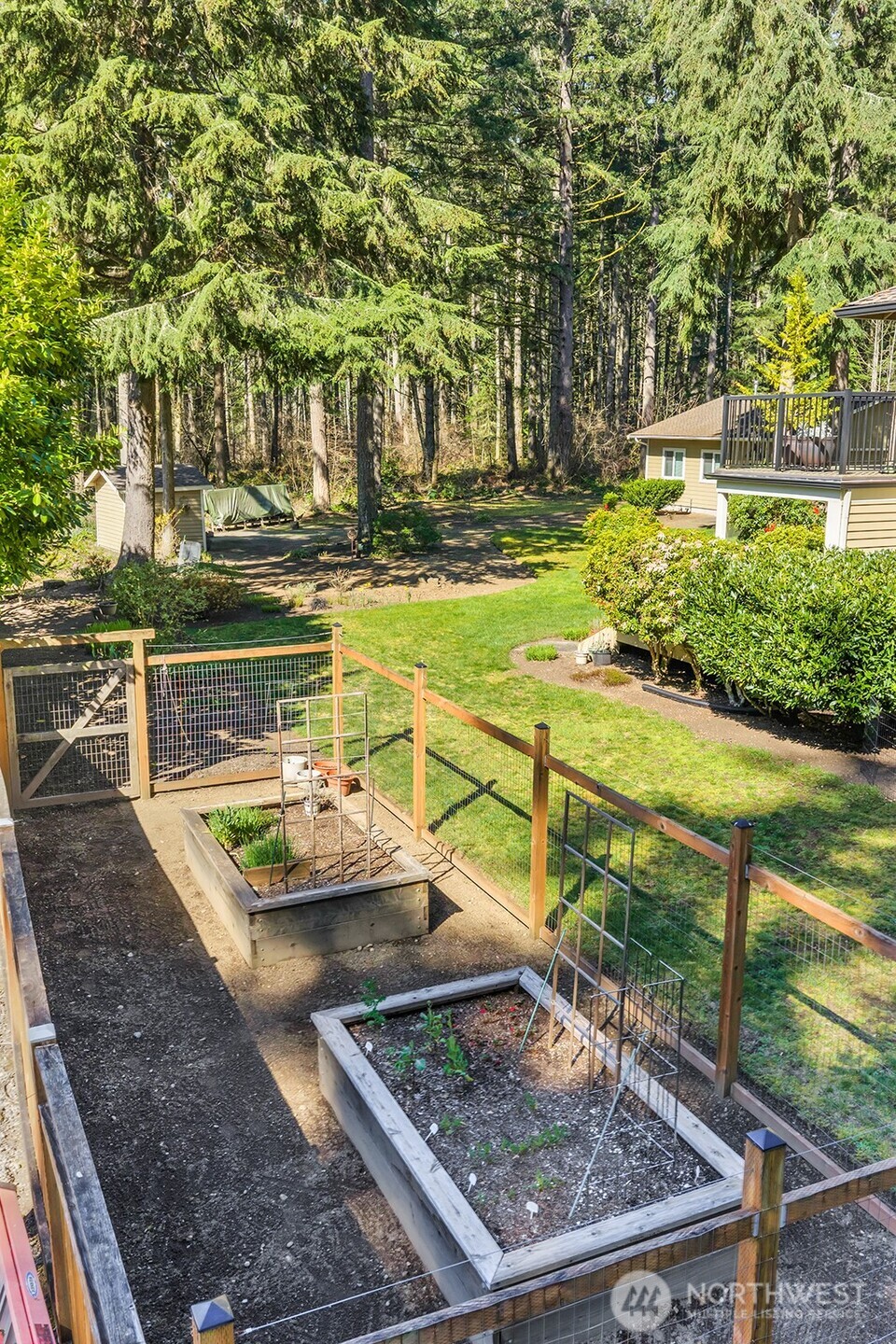 Raised beds for the avid gardener, fenced so deer can only enjoy looking at the harvest