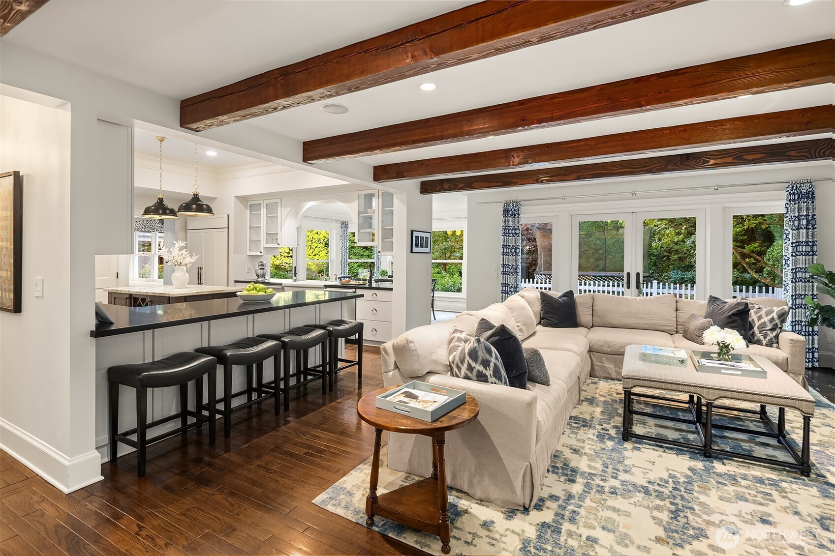 A beamed great room that opens to a covered patio for year-round entertaining.