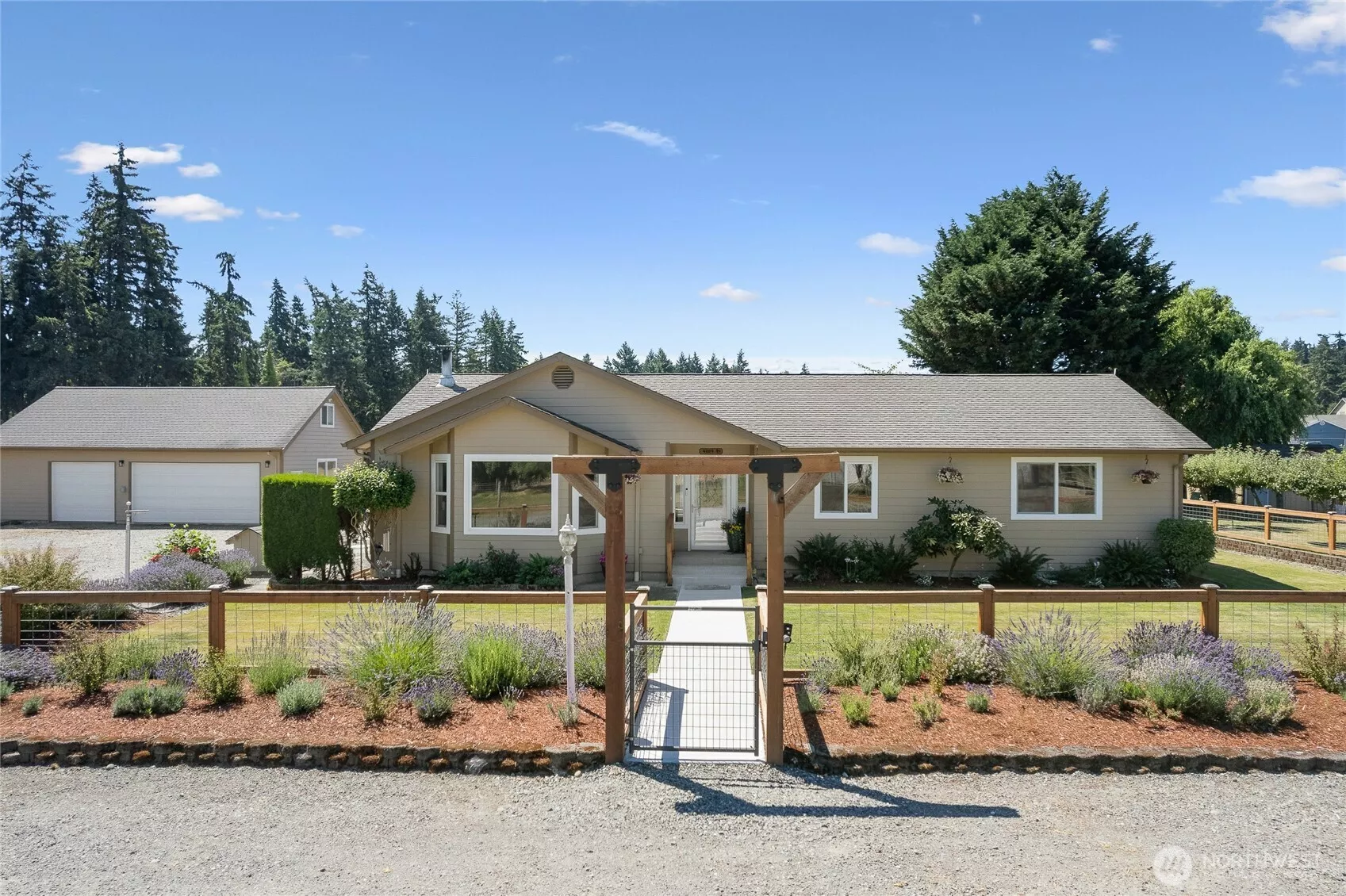 Home plus large detached garage with shop and attic, surrounded by beautiful English garden landscaping.