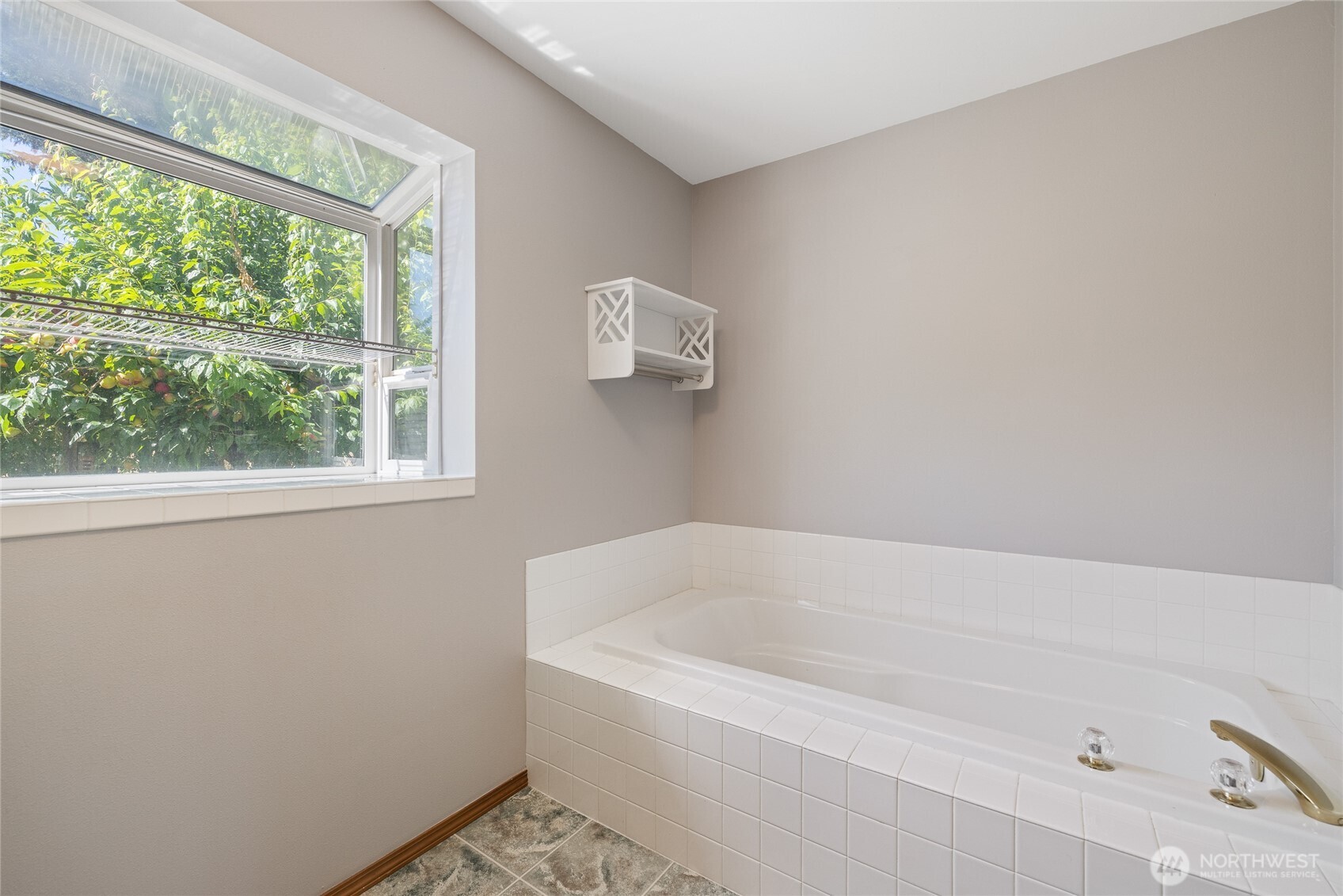 Custom California Closets enhance both the pantry and primary suite. The primary bath features a six-foot soaking tub and a cable TV hookup.