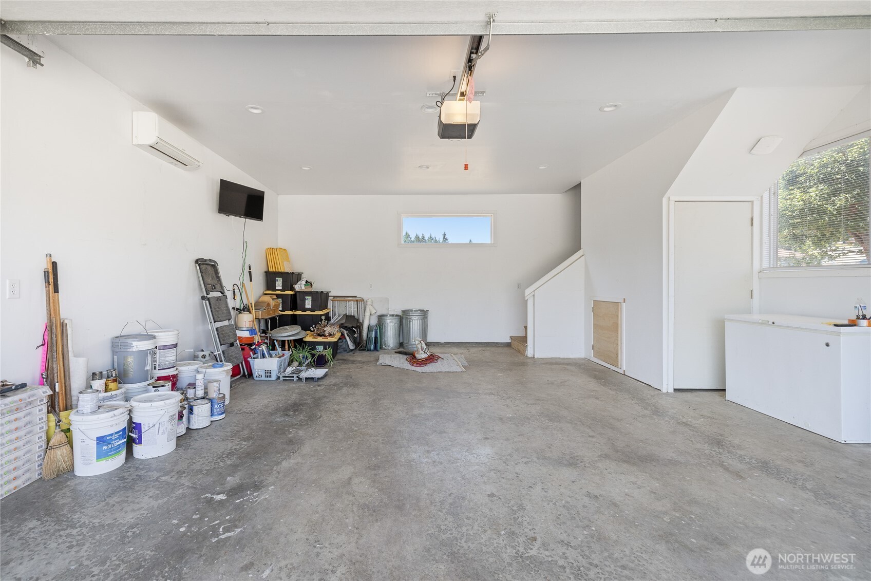 The garage and shop are fully insulated and equipped with a ductless heat pump for year-round usability. The space is piped for an air compressor, which stays with the property, and includes a 50-amp outlet for electric vehicle charging. Built-in cabinetry and a mini fridge are included, along with a dedicated gun safe cabinet (safe not included). A 220-volt welding plug and a 200-amp service panel support a wide range of uses.