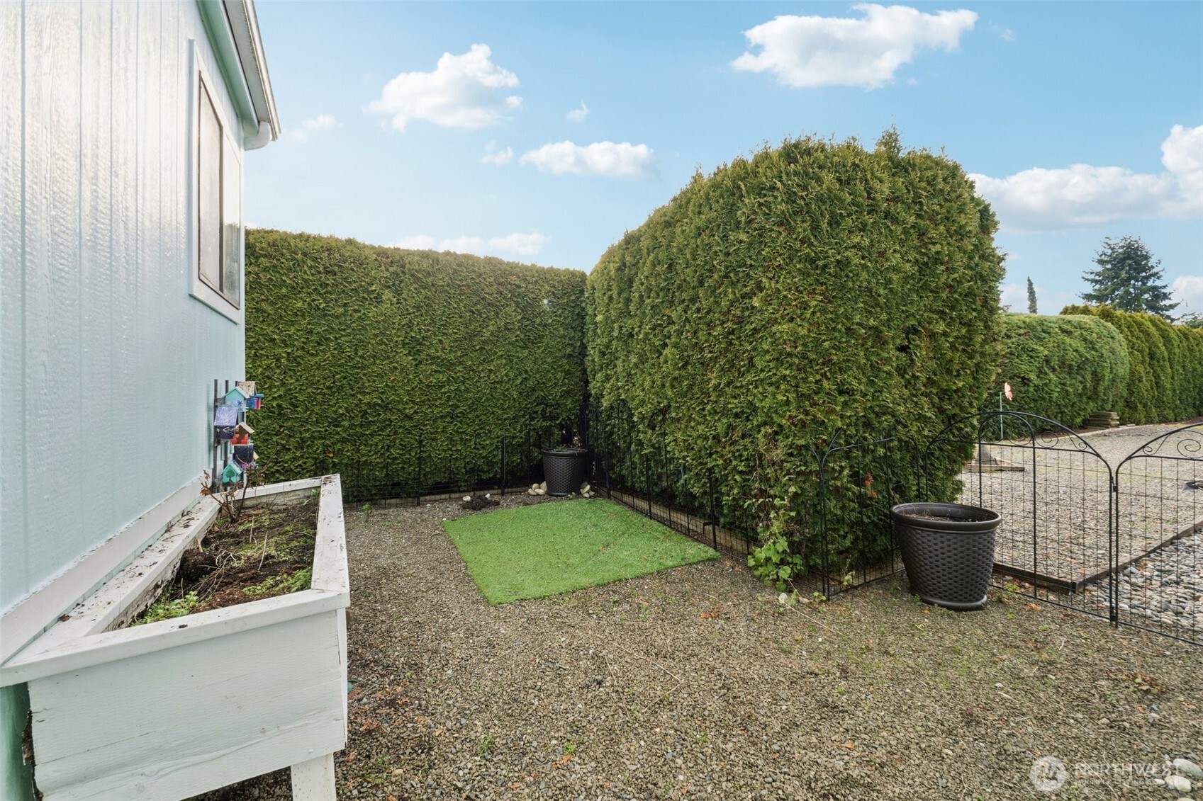 Large storage shed located at the end of the carport